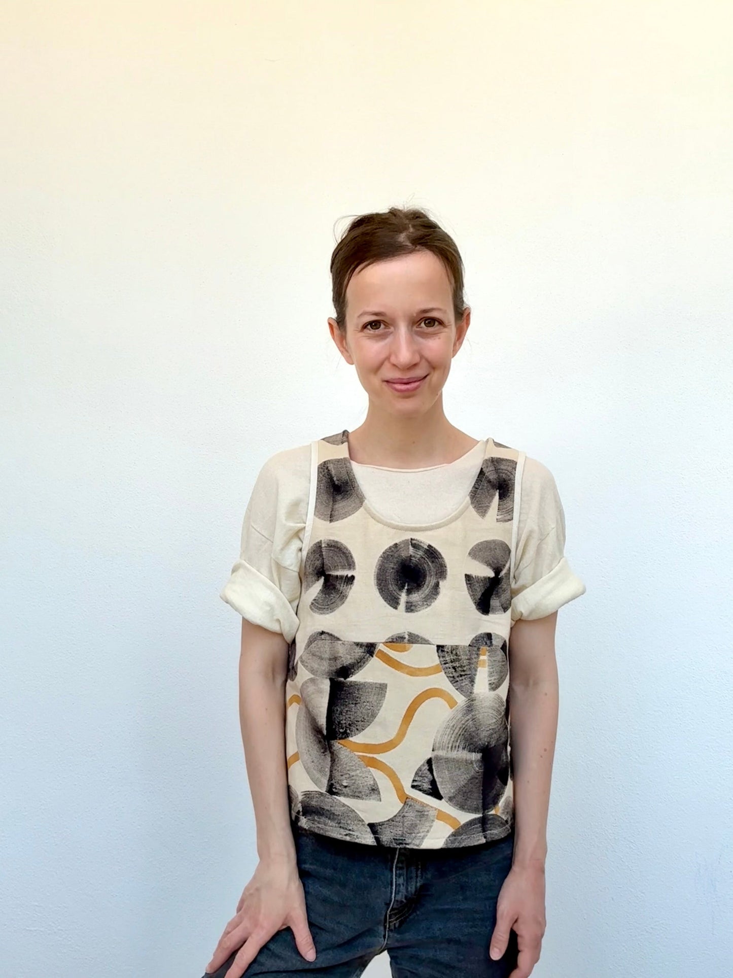 woman wearing a vest-top that was hand-painted with ferrous paste and cosmos sulphureus dye paste by DOT 'N' POT