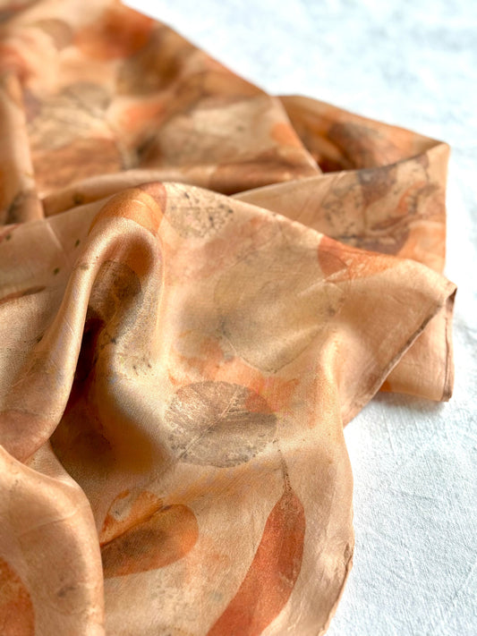 eco-printed orange silk scarf detail with floral pattern