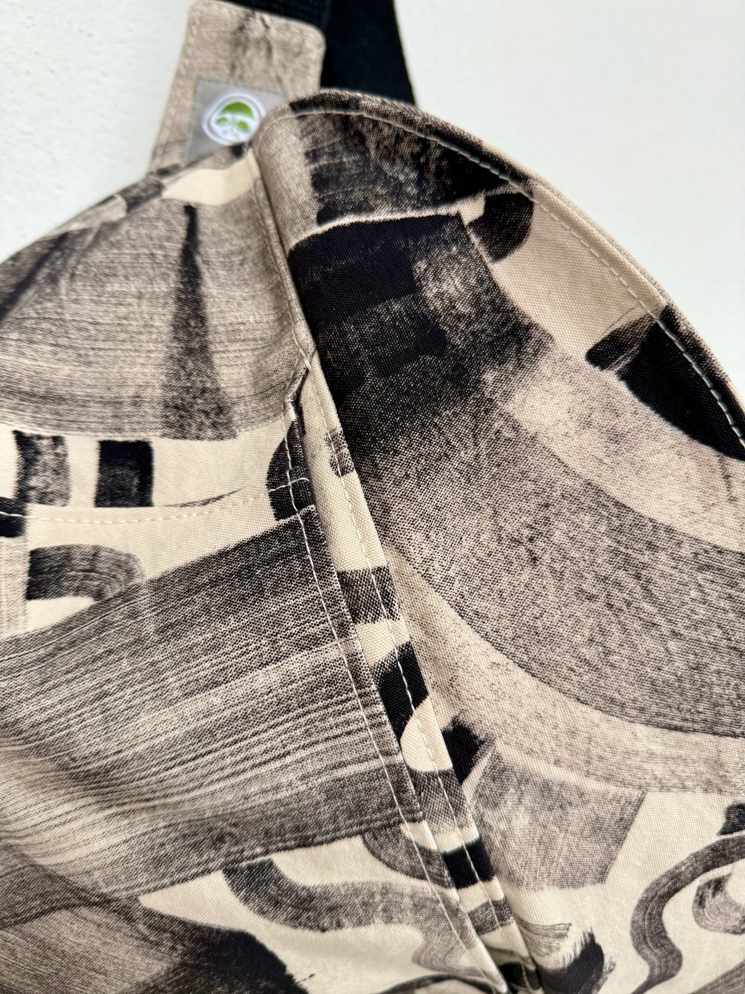 a close detail of a bag hand painted with natural ferrous paste leaving black marks, from the BAGS & POUCHES collection