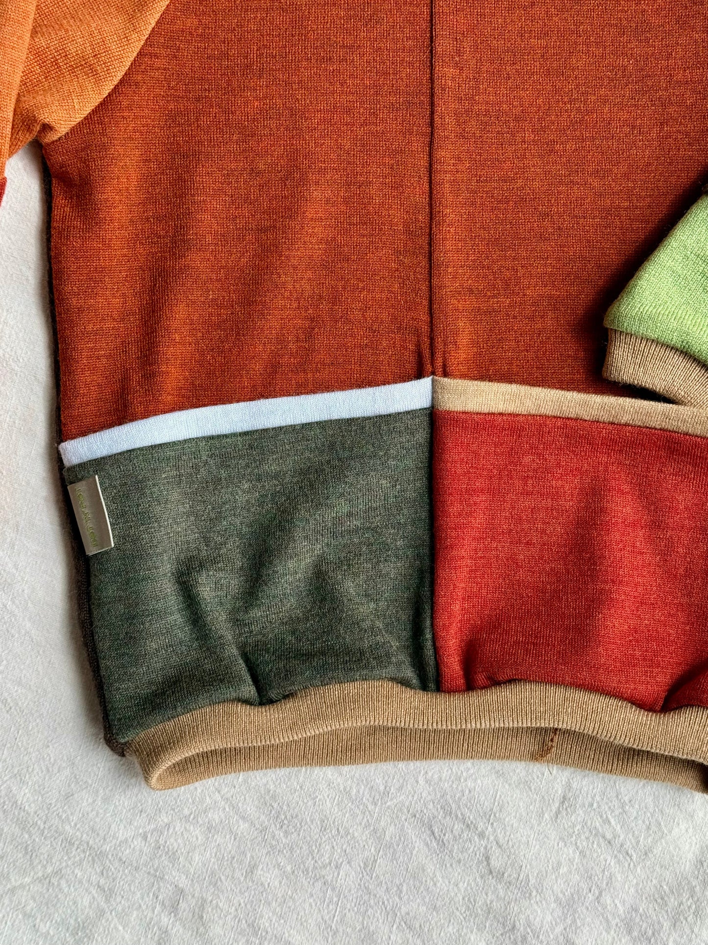 front pockets of a colorful upcycled merino wool sweater for kids