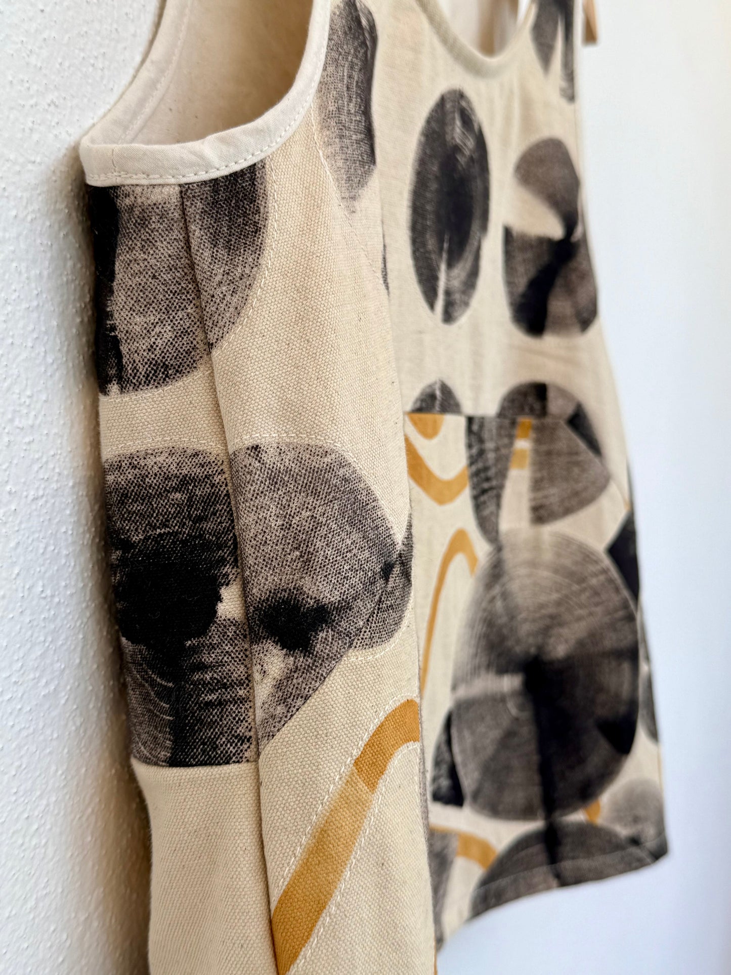 Close-up of the sewing - beige top with hand-painted, naturally colored patterns
