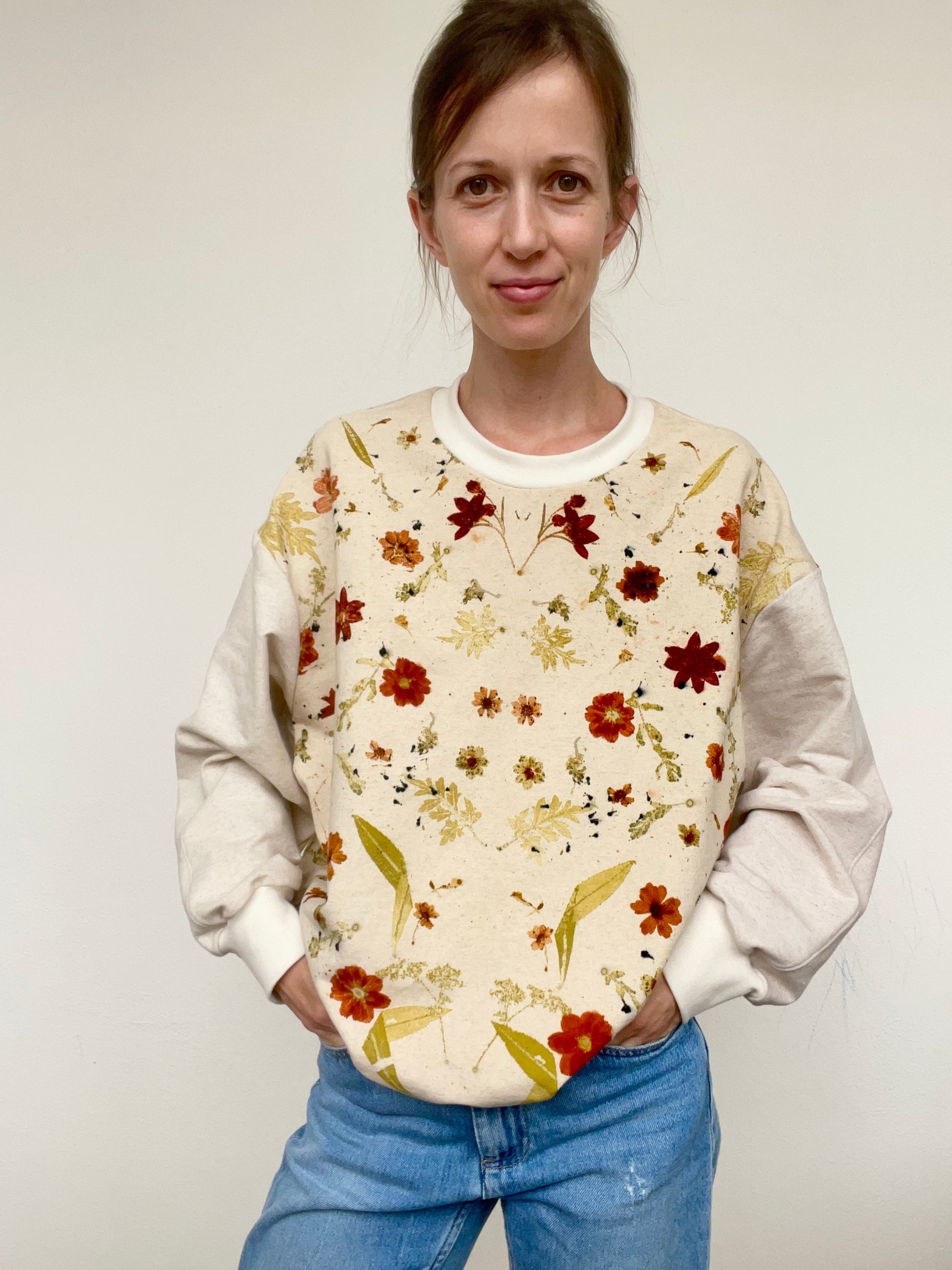 Woman wearing a floral-patterned sweater, eco-printed with real flowers, by DOT 'N' POT