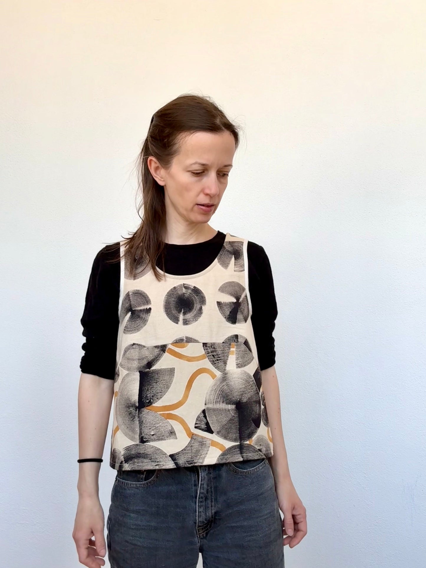 woman wearing a hand-painted top by DOT 'N' POT against a white background