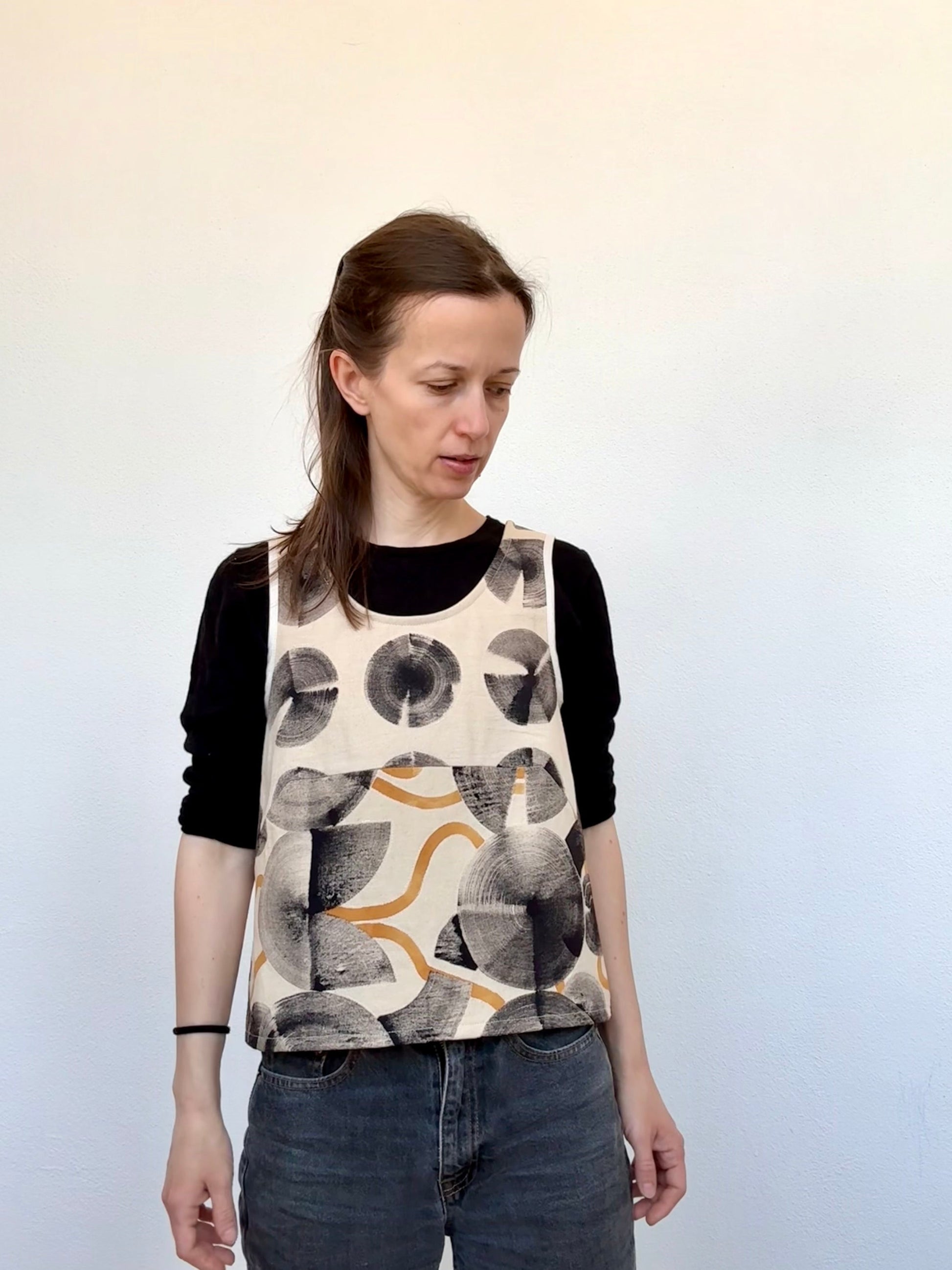 woman wearing a hand-painted top by DOT 'N' POT against a white background