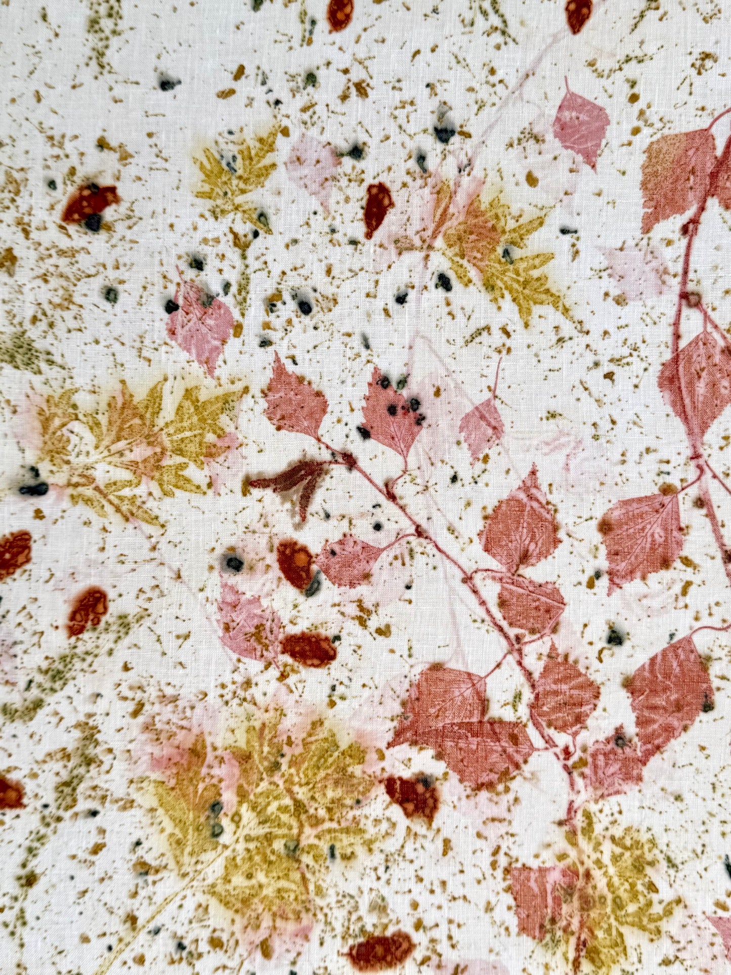 Close-up of an eco-printed hemp fabric with cosmos green leaf patterns