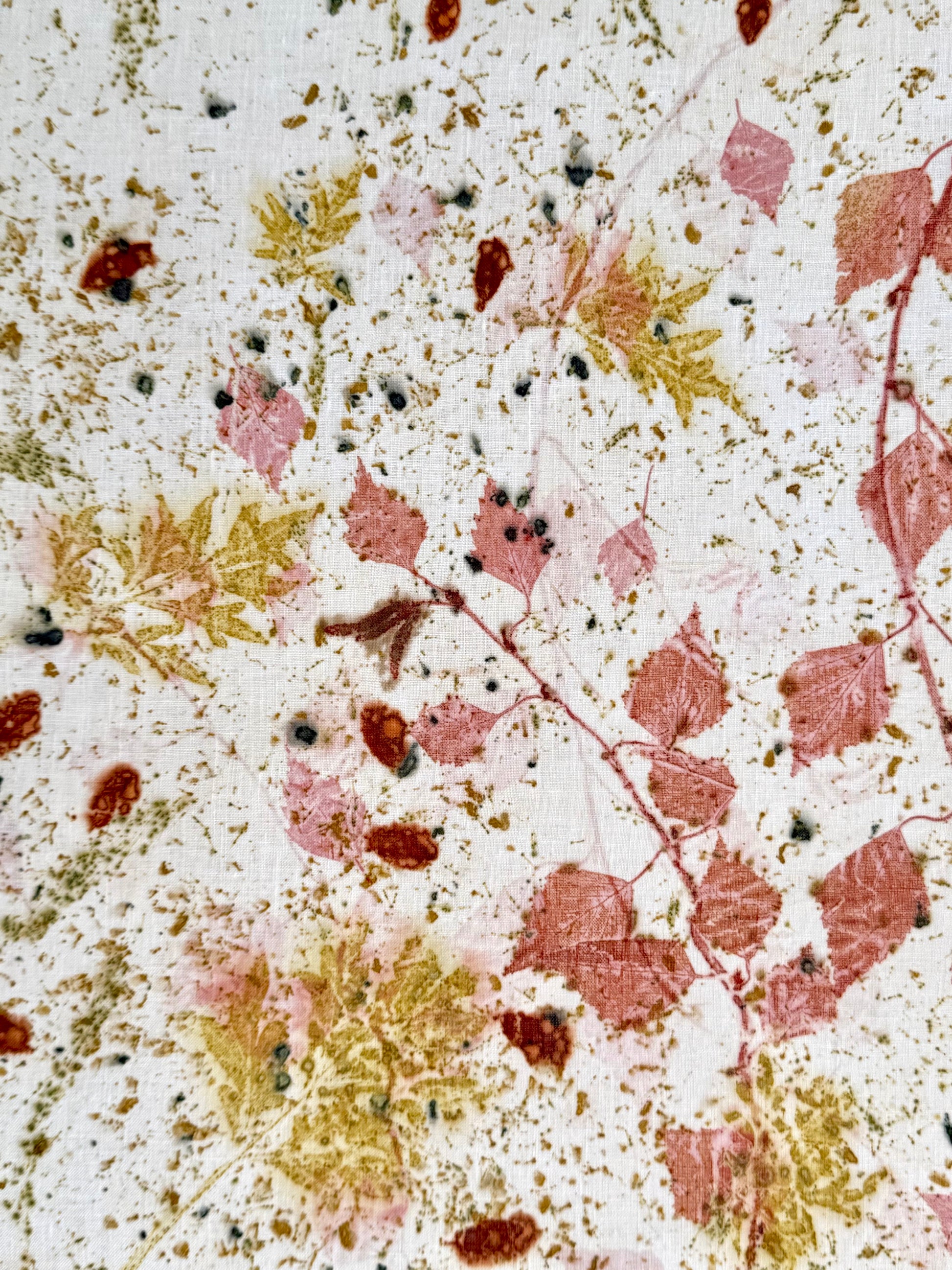Close-up of an eco-printed hemp fabric with cosmos green leaf patterns
