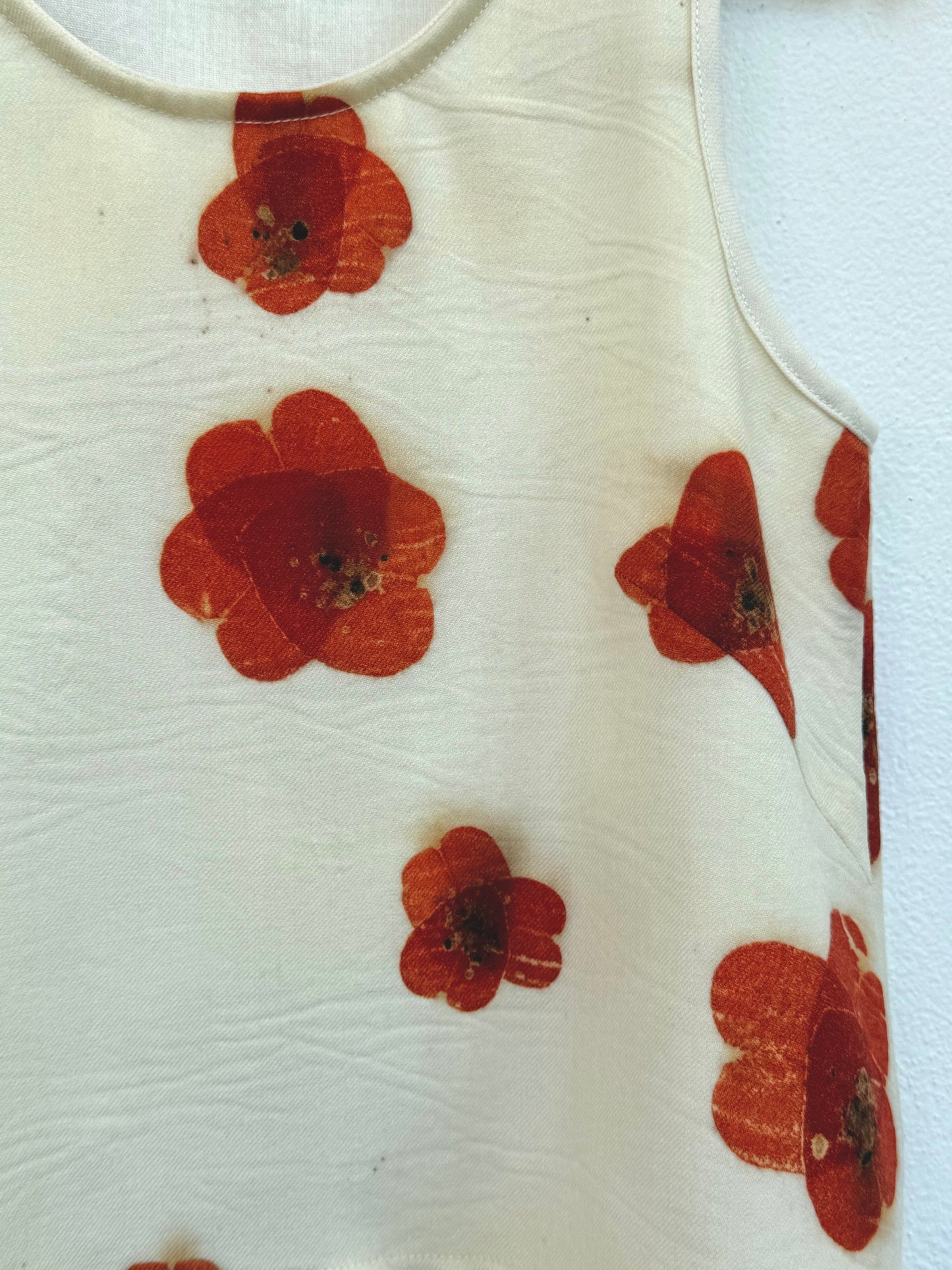 Beige tank top with red floral pattern eco-printed  - close-up of the poppy pattern