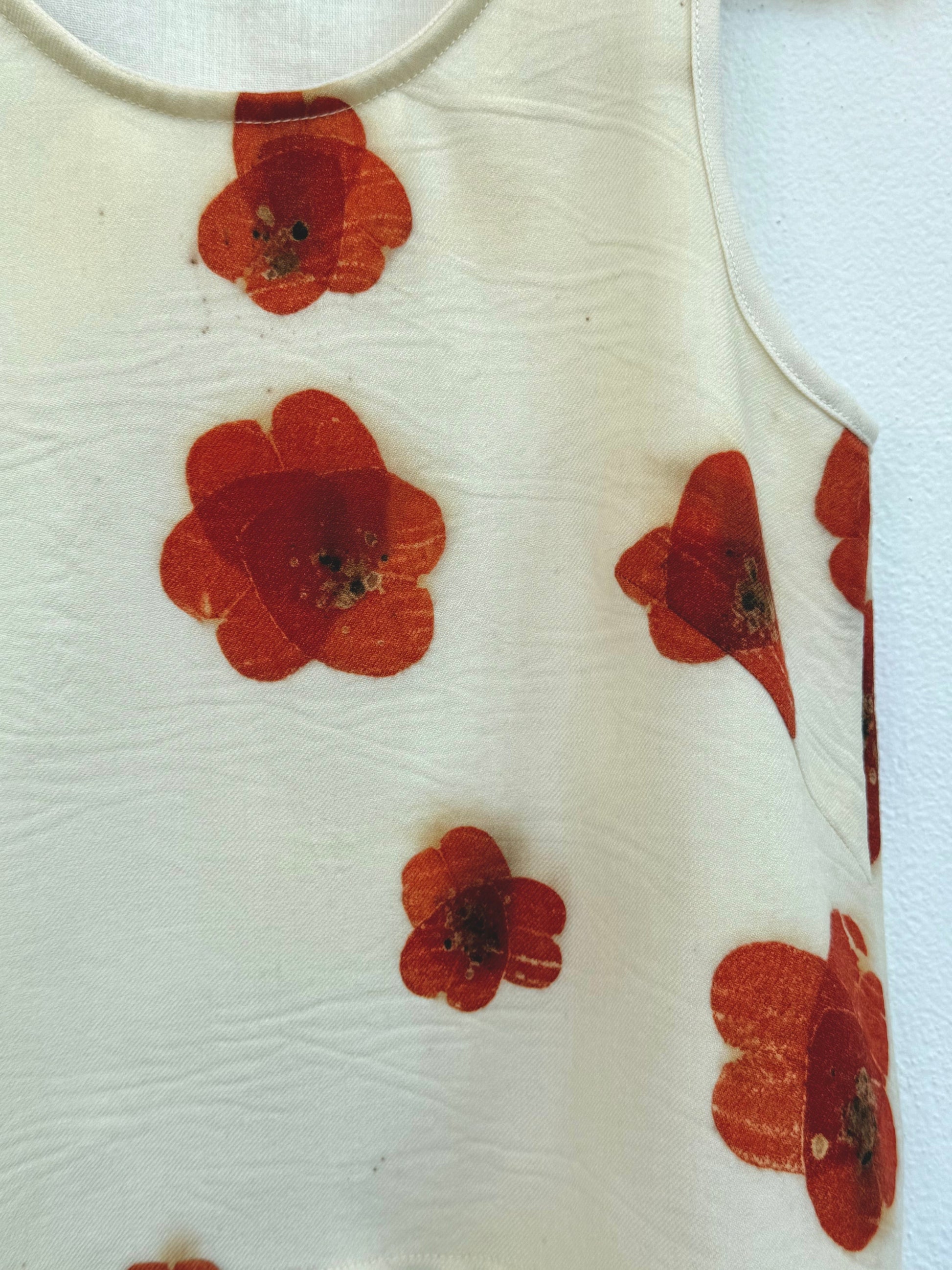 Beige tank top with red floral pattern eco-printed  - close-up of the poppy pattern