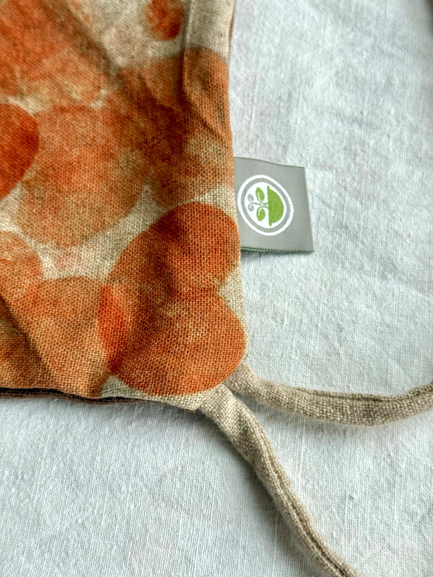 close-up of the texture of a naturally dyed woolen bag with DOT 'N' POT logo