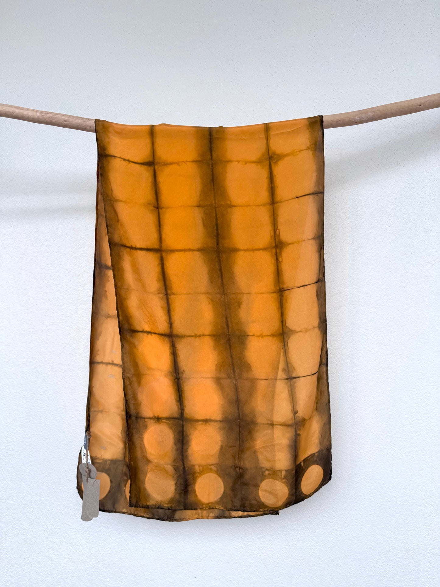 Brown and orange tie-dye scarf on a white background