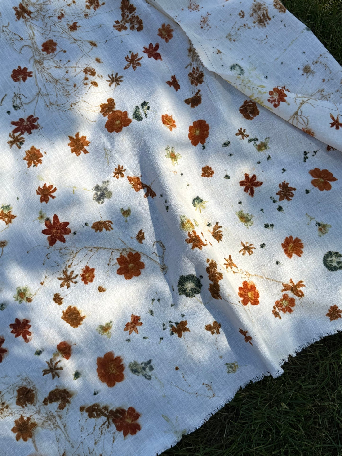 Floral patterned, eco-printed fabric with a white background by DOT 'N' POT