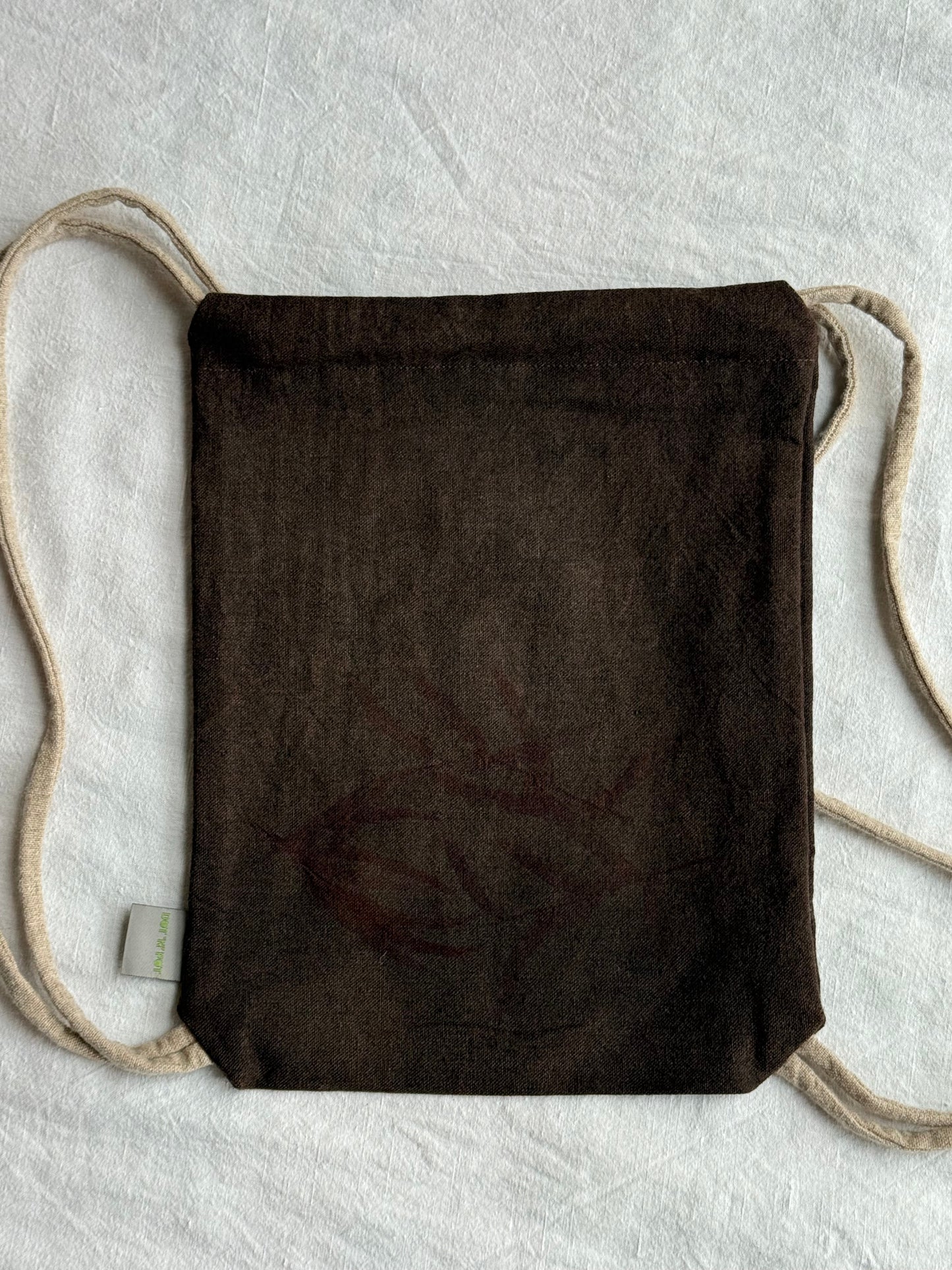 back of a dark brown naturally dyed woolen drawstring bag