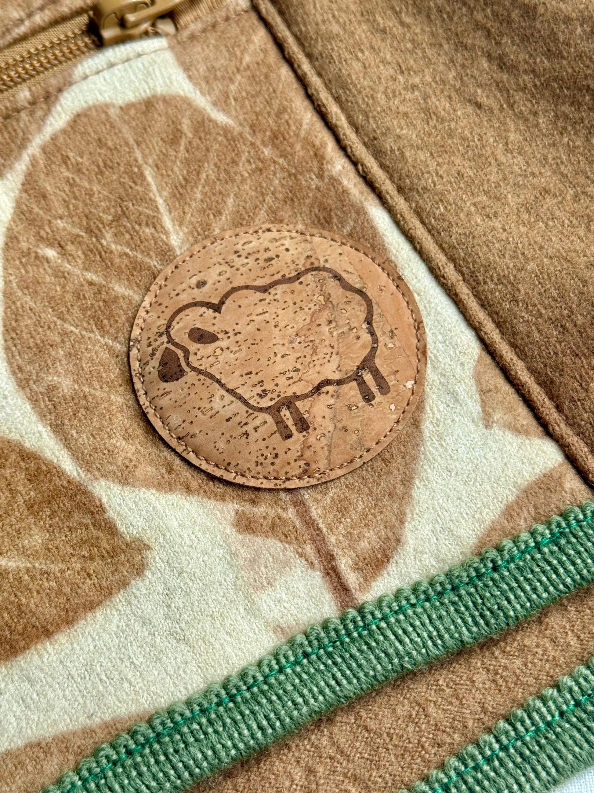 Close-up of a sheep cork patch on a walnut dyed kid sweater