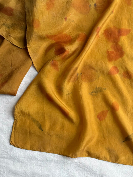 silk scarf naturally dyed with onion skins and eco-printed with eucalyptus leaves - a close-up