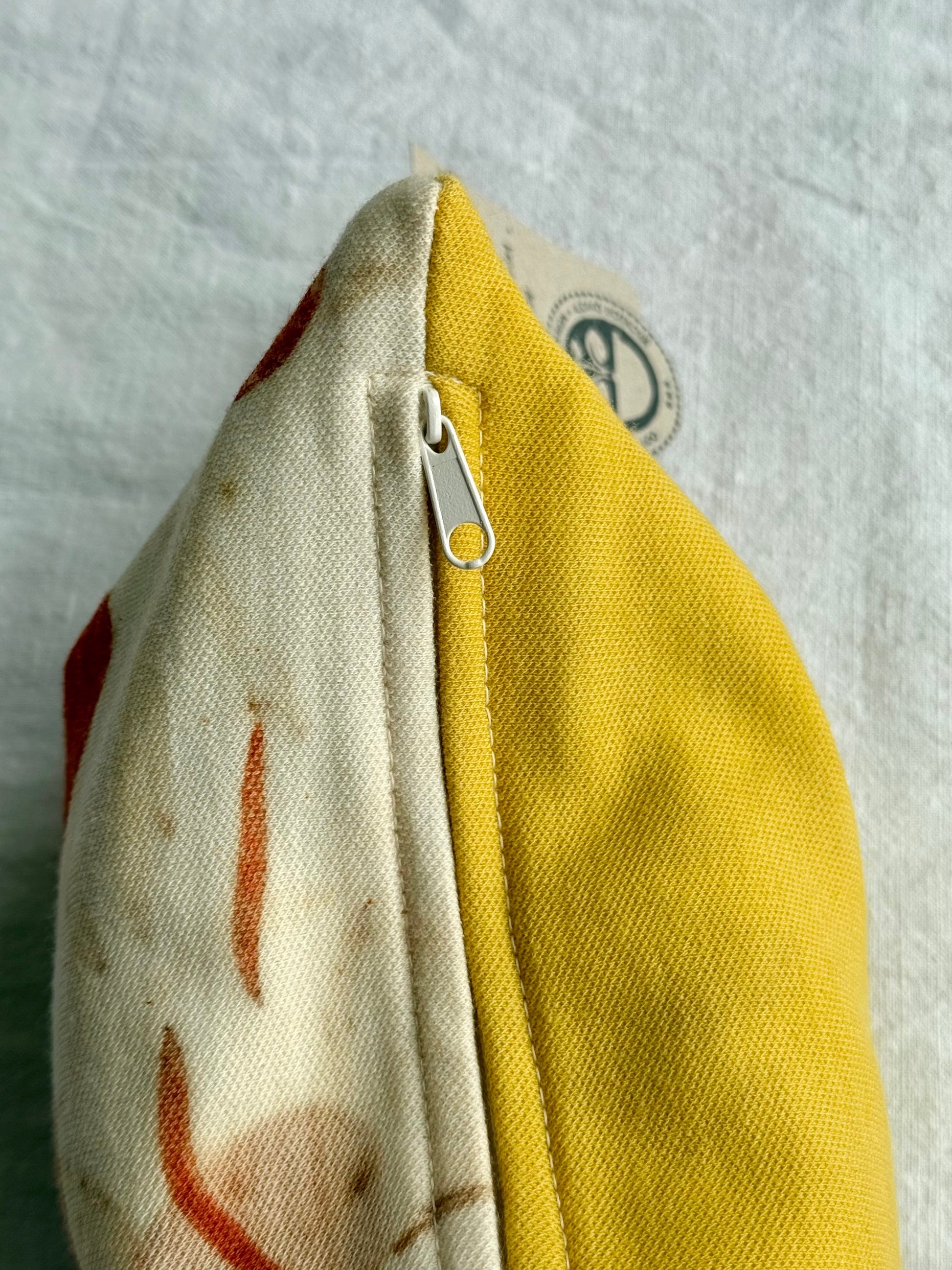 Zipper detail of a herbal pillow dyed with Weld and eco-printed