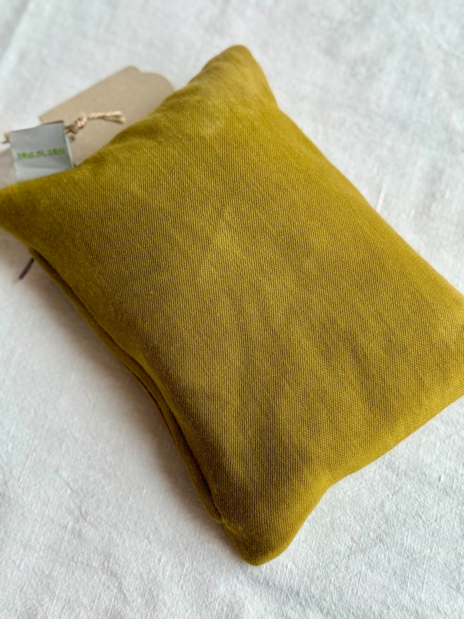 Back of a herbal pillow dyed natural green with onion skins