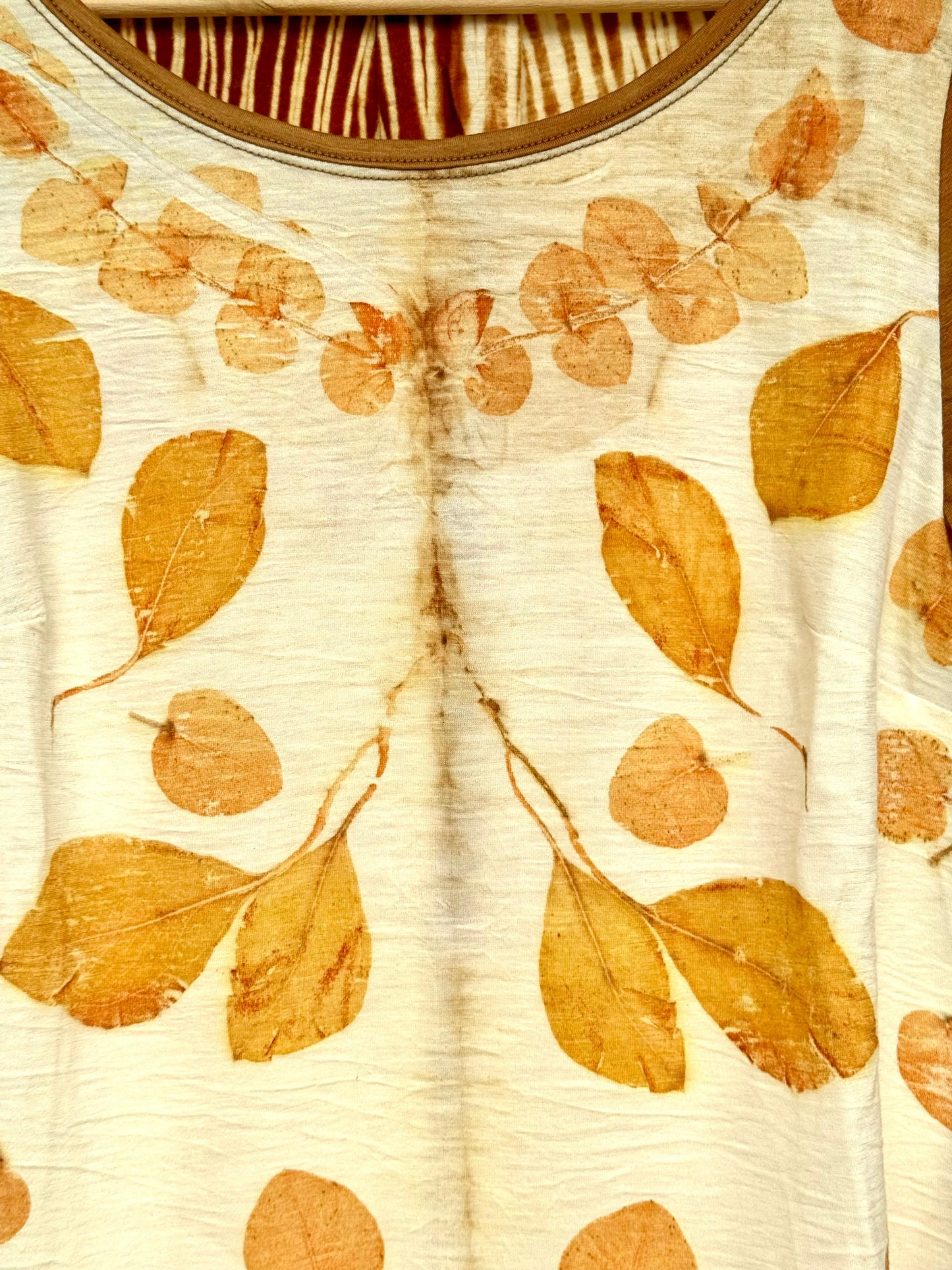 Close-up of a merino top with eucalyptus  leaf pattern on a beige background