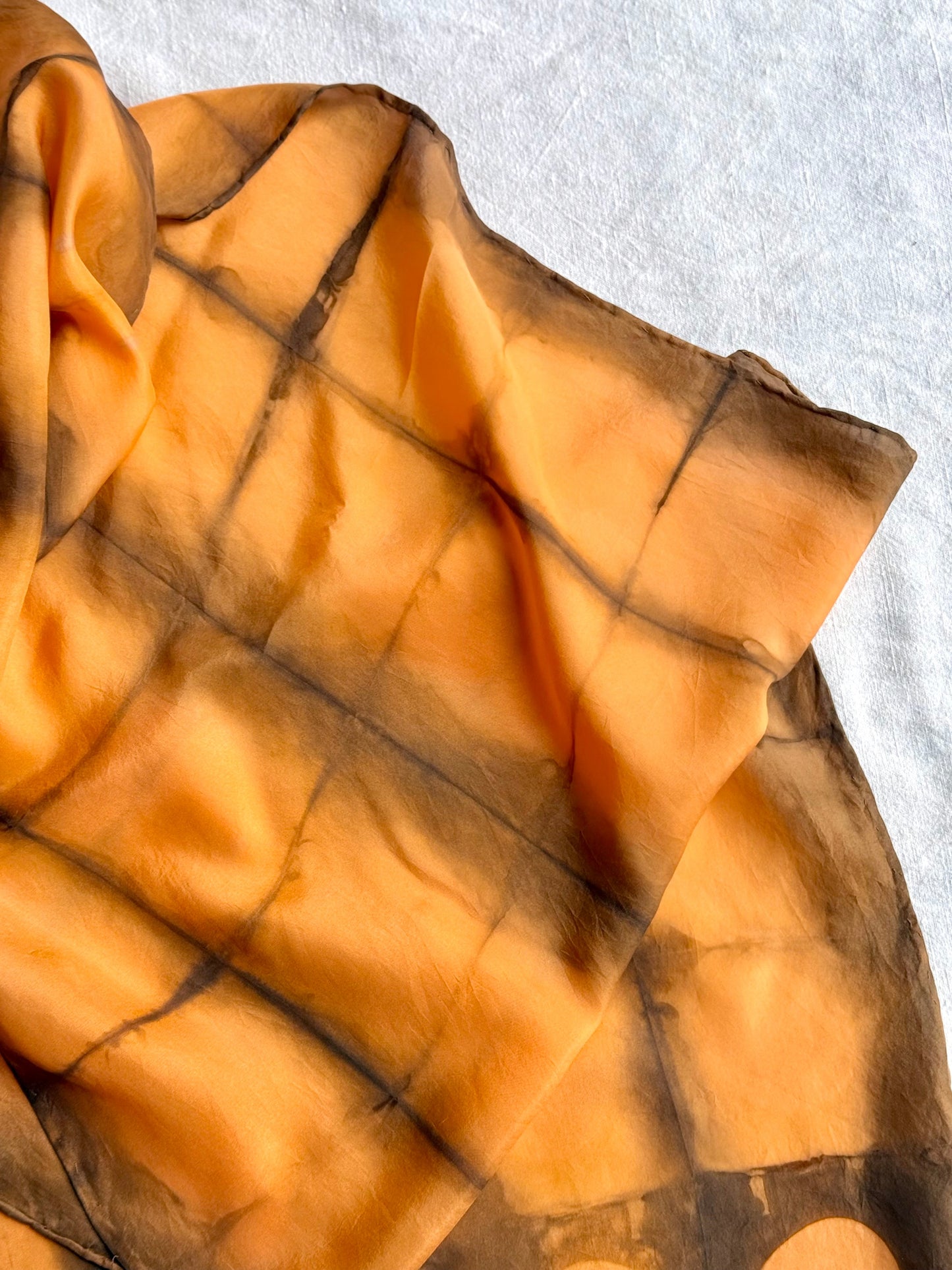 square shibori silk scarf naturally dyed with annatto seeds and sweet chestnut leaves