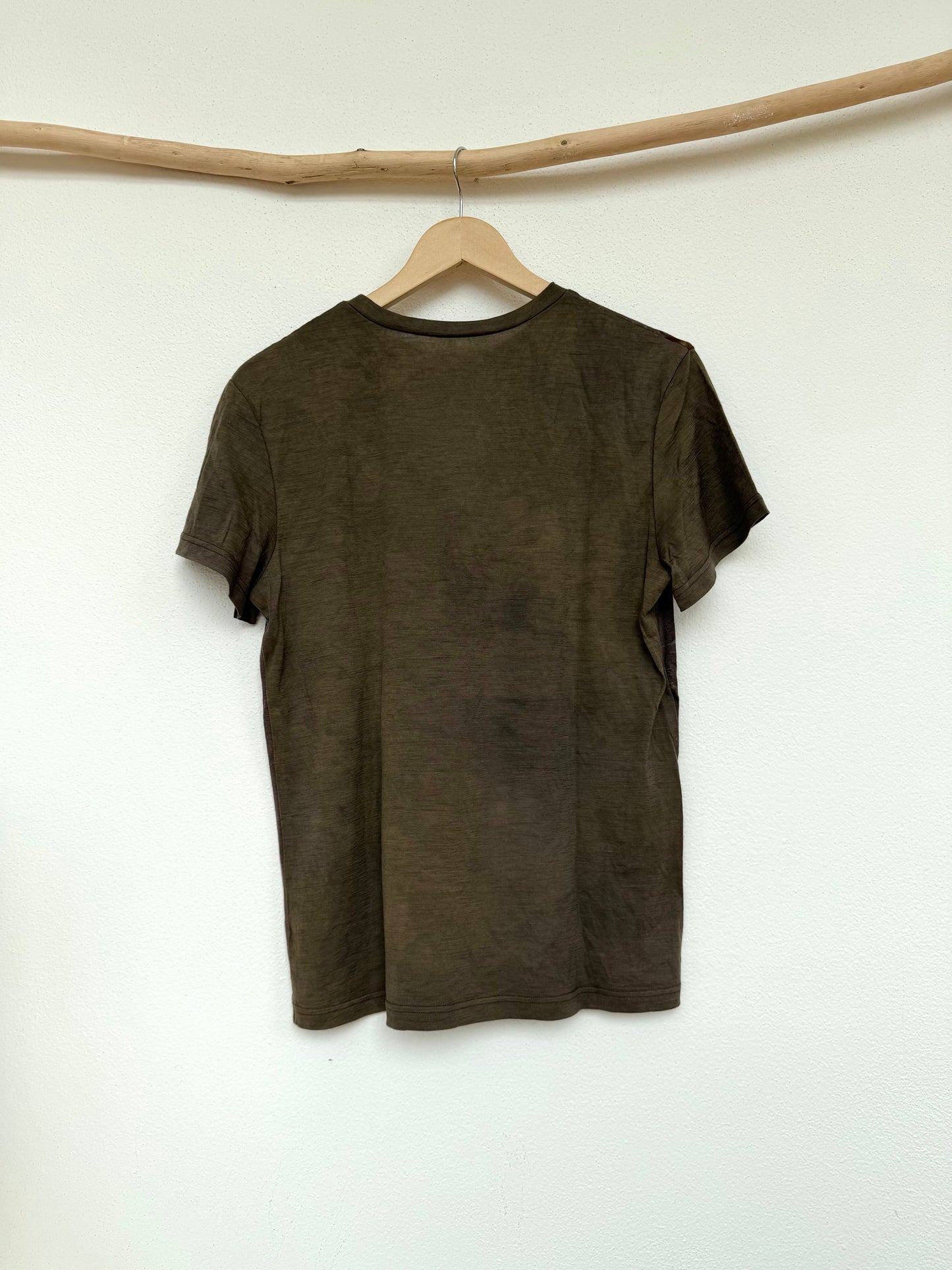 back part of a naturally gray-green dyed merino wool t-shirt 
