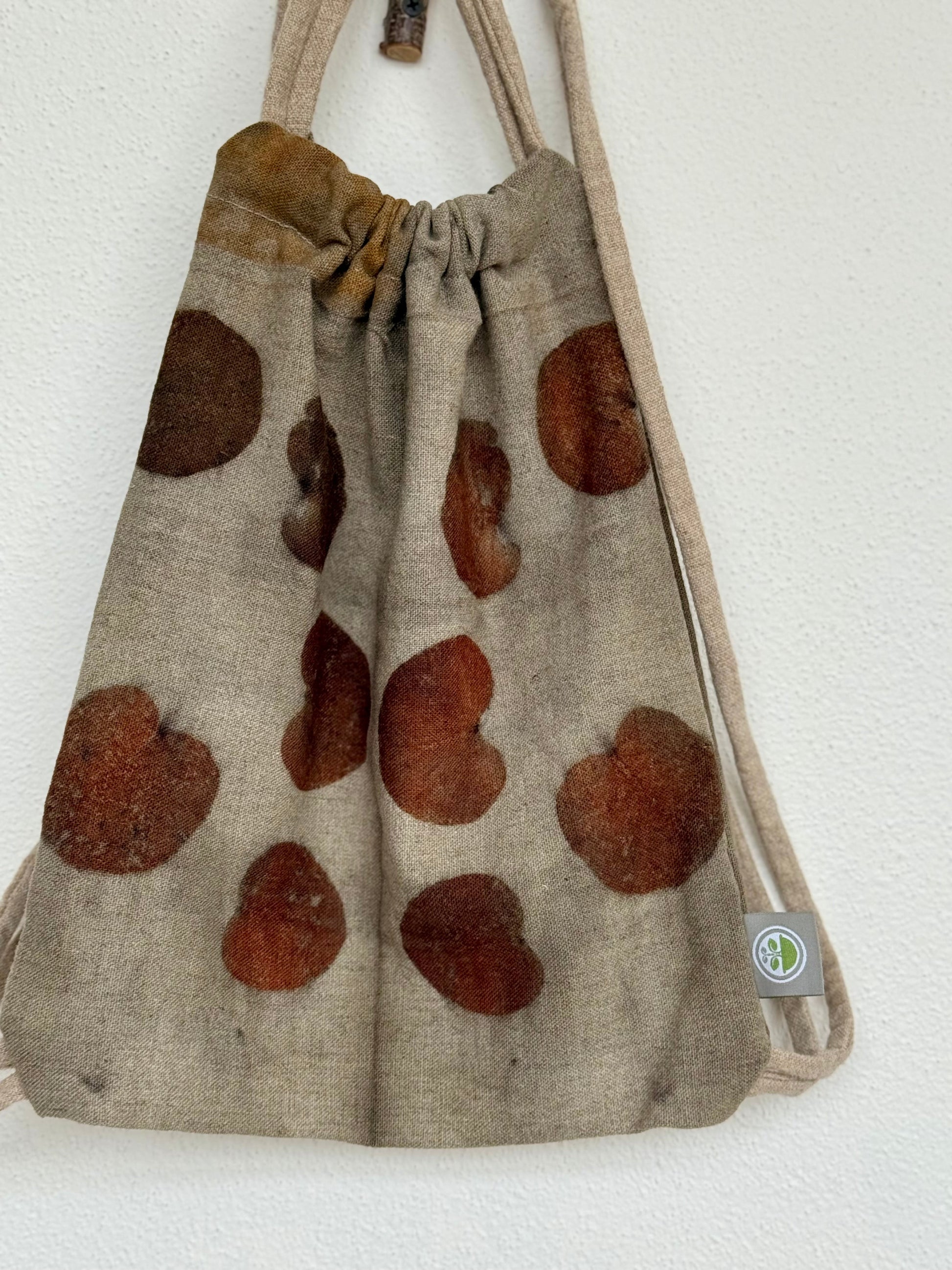 front of a woolen drawstring bag with eco-print made with eucalyptus leaves by DOT 'N' POT