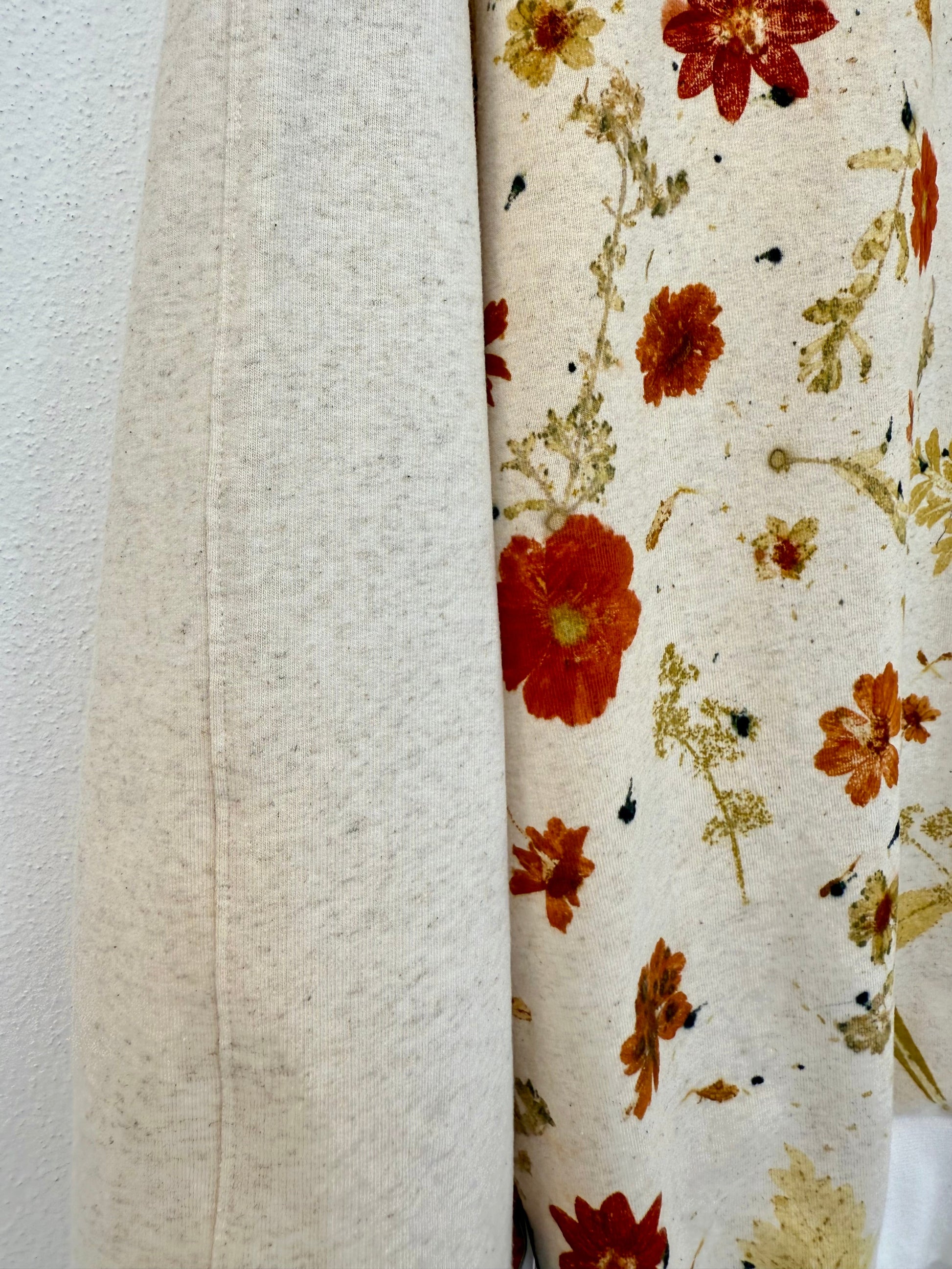 detail of a floral eco-print pattern on a natural colored sweater