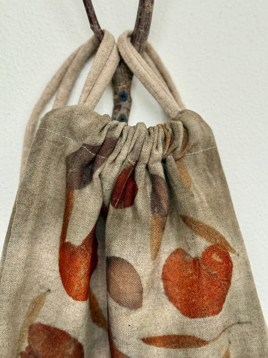 Drawstring woolen bag detail with eco-printed leaf pattern on a white background