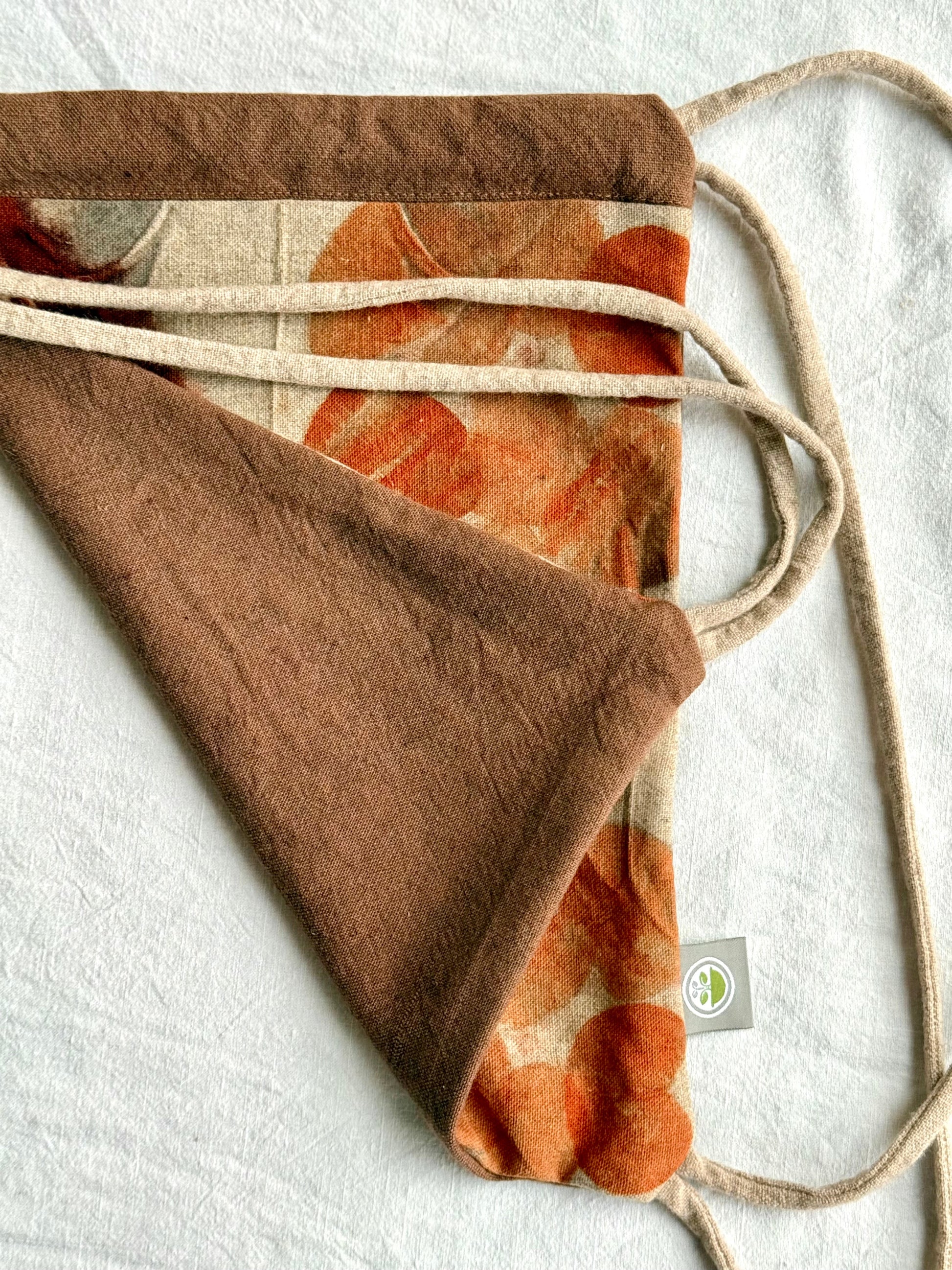 front and back of a woolen drawstring bag naturally dyed brown an orange