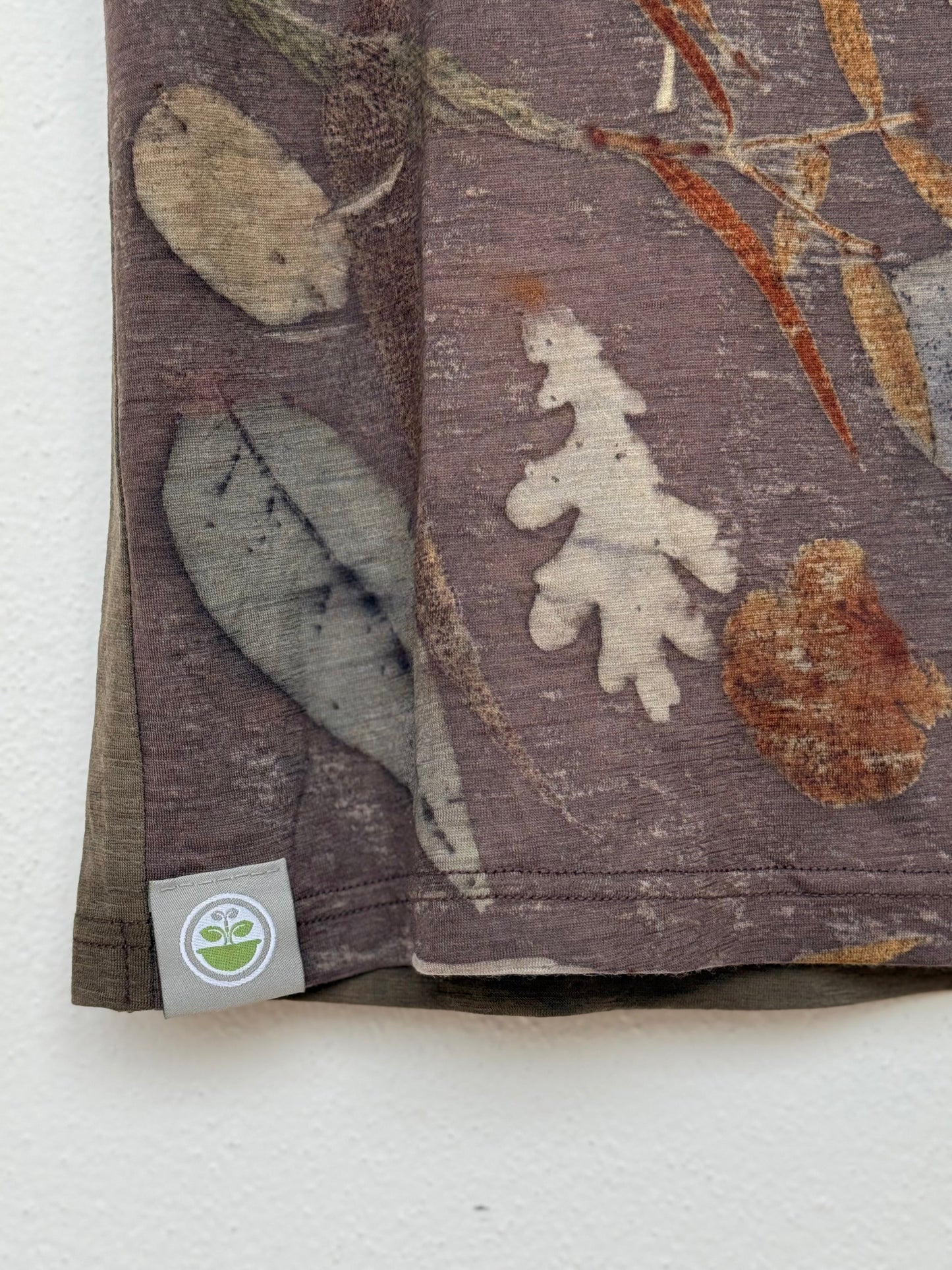 men's eco-printed t-shirt by DOT 'N' POT - close-up of the tag with logo