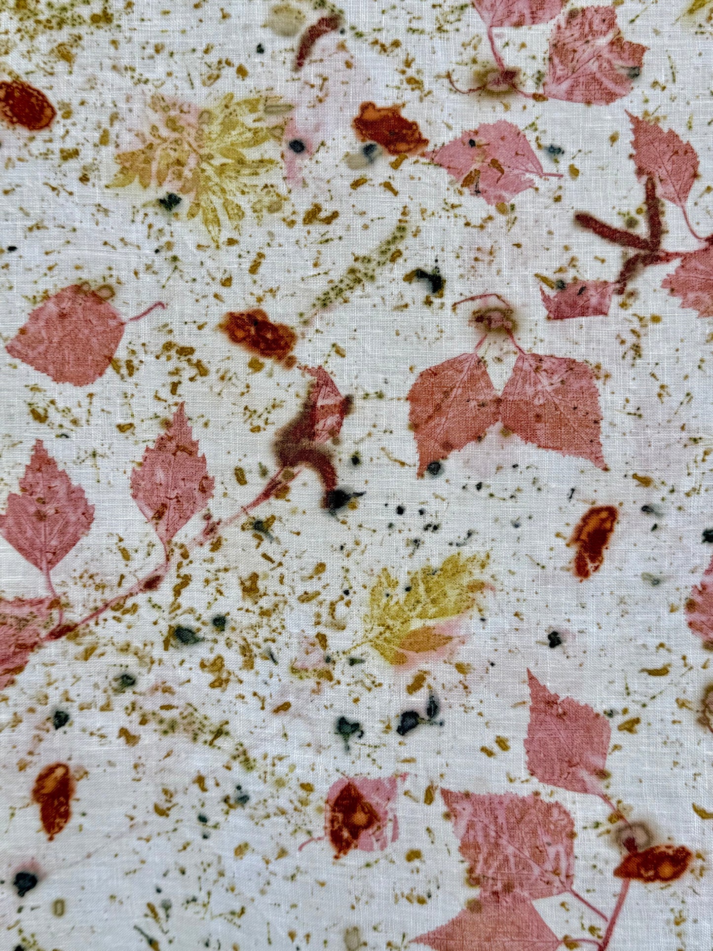 Close-up of an eco-printed hemp fabric with madder red infused birch leaves