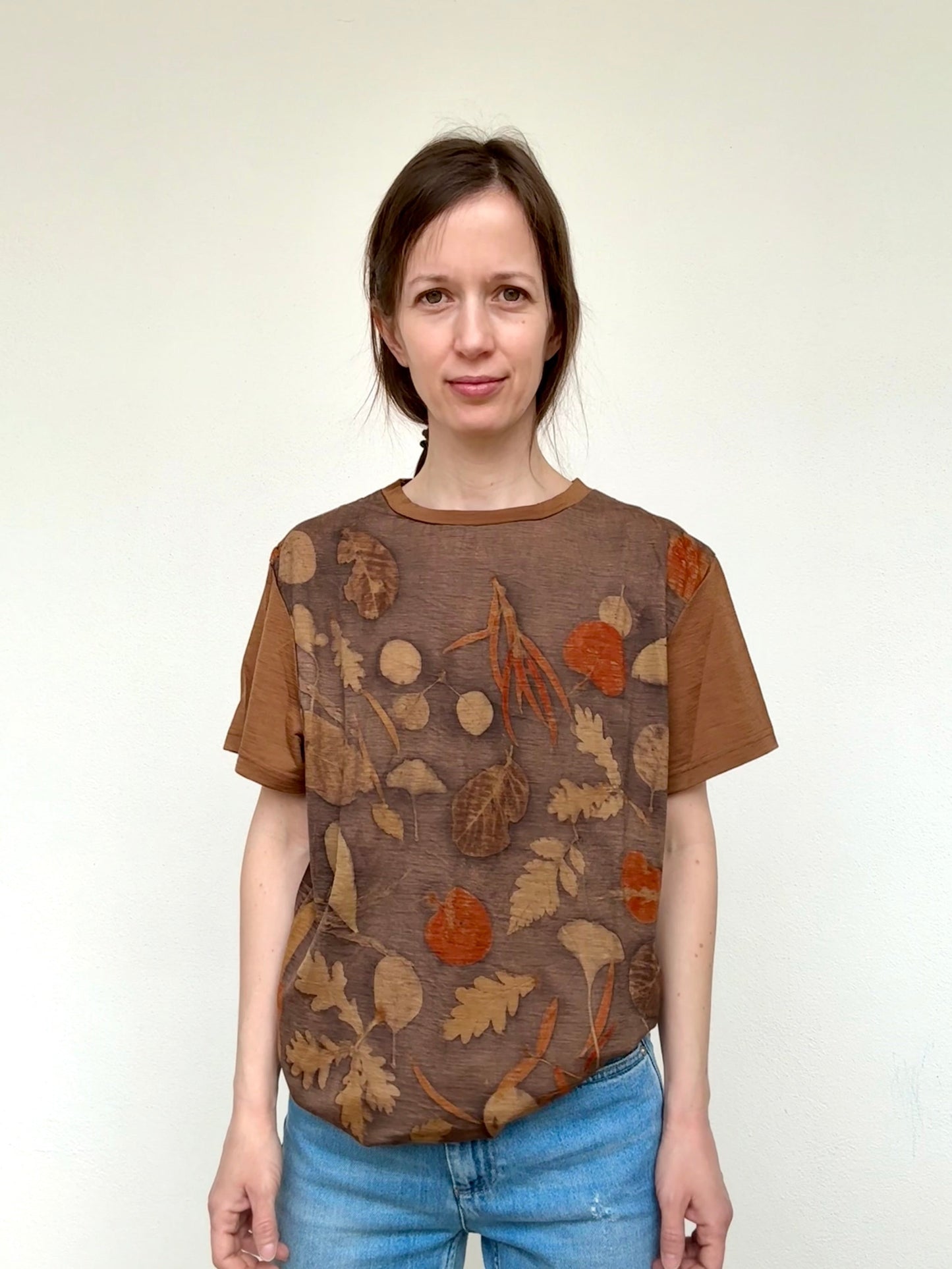 Woman wearing a naturally brown dyed merino wool t-shirt with eco-printed floral pattern by DOT 'N' POT