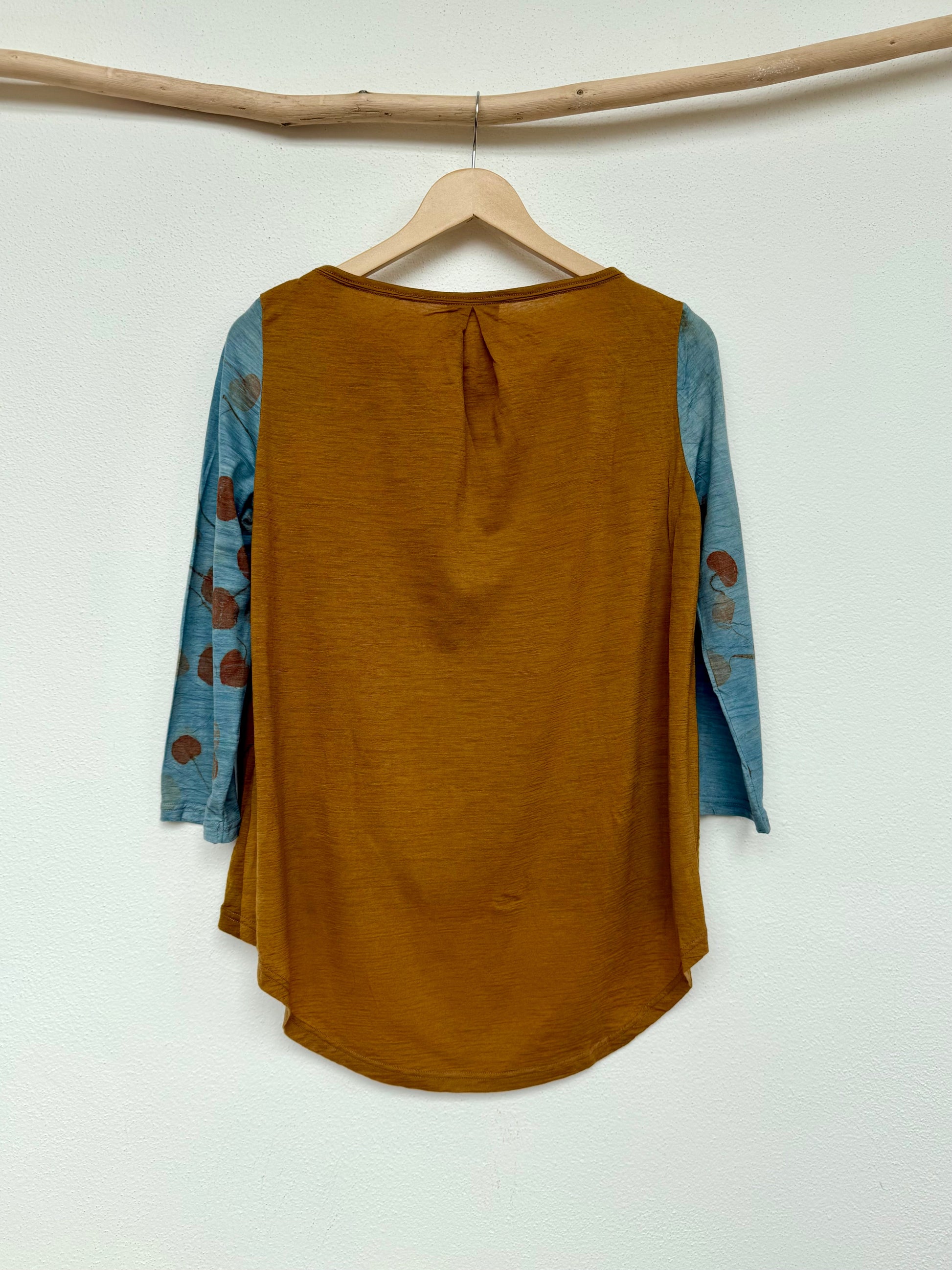 back of a merino wool women's top naturally dyed with red onion skins and indigo sleeves featuring eucalyptus eco-prints