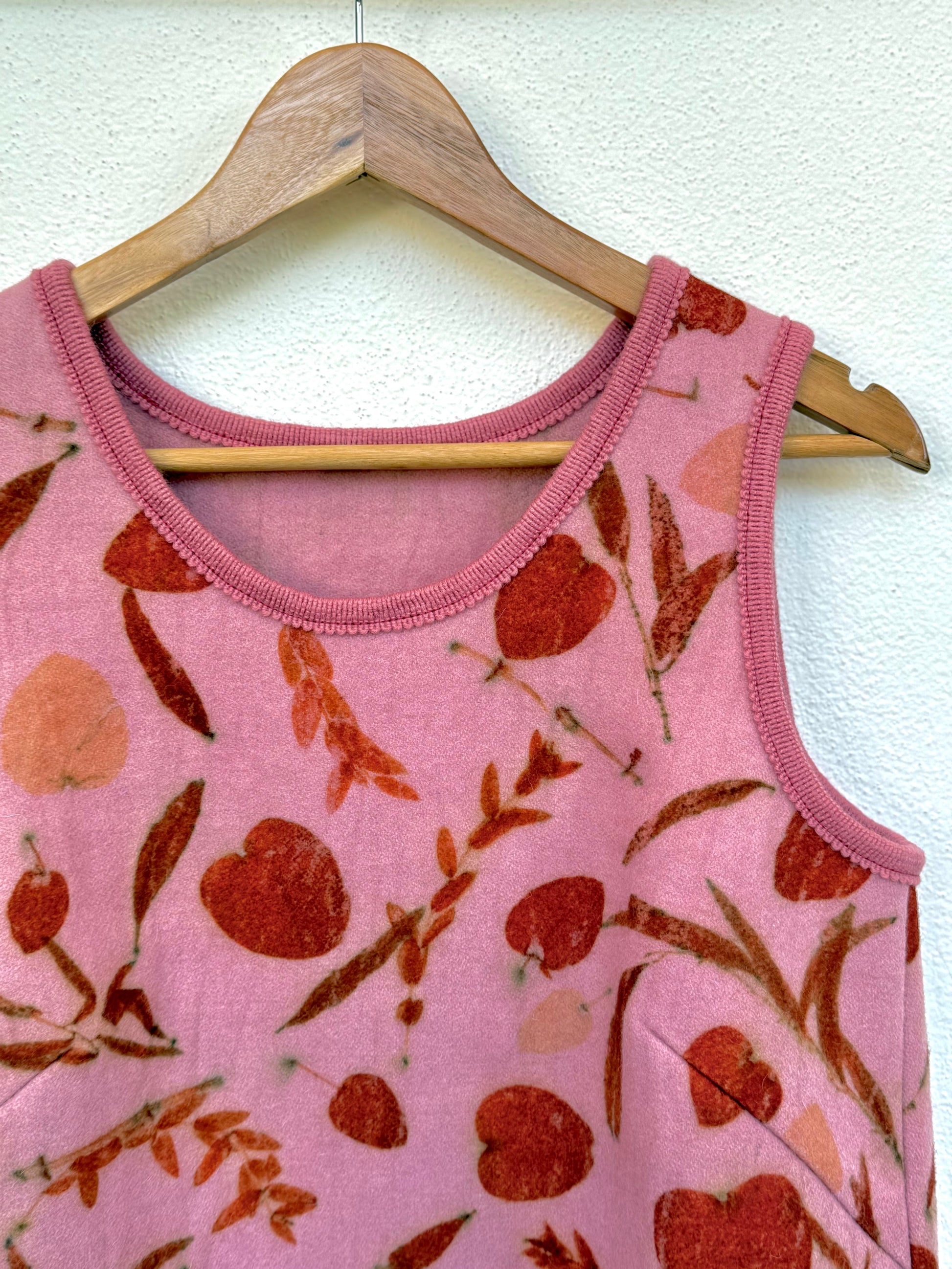 close-up of the front part and neckline of a cochineal dyed pink women's vest