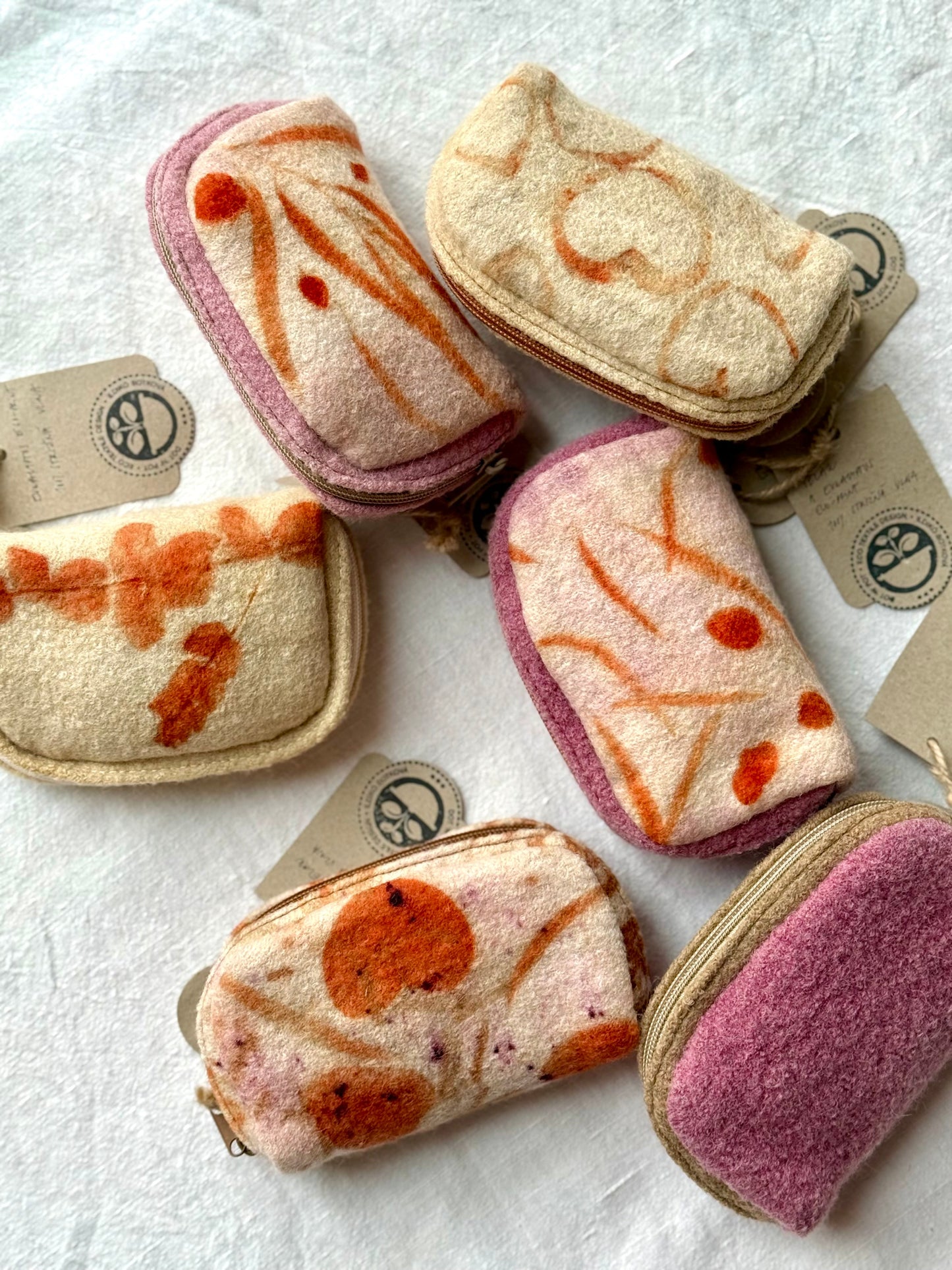 Six naturally dyed and eco-printed eucalyptus woolen purses by DOT 'N' POT