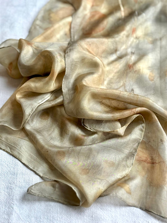 detail of a silk scarf with green-gray color, naturally dyed