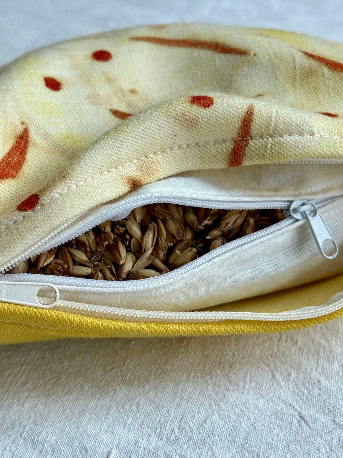 Herbal pillow close-up with spelt husks filling and ecalyptus eco-print