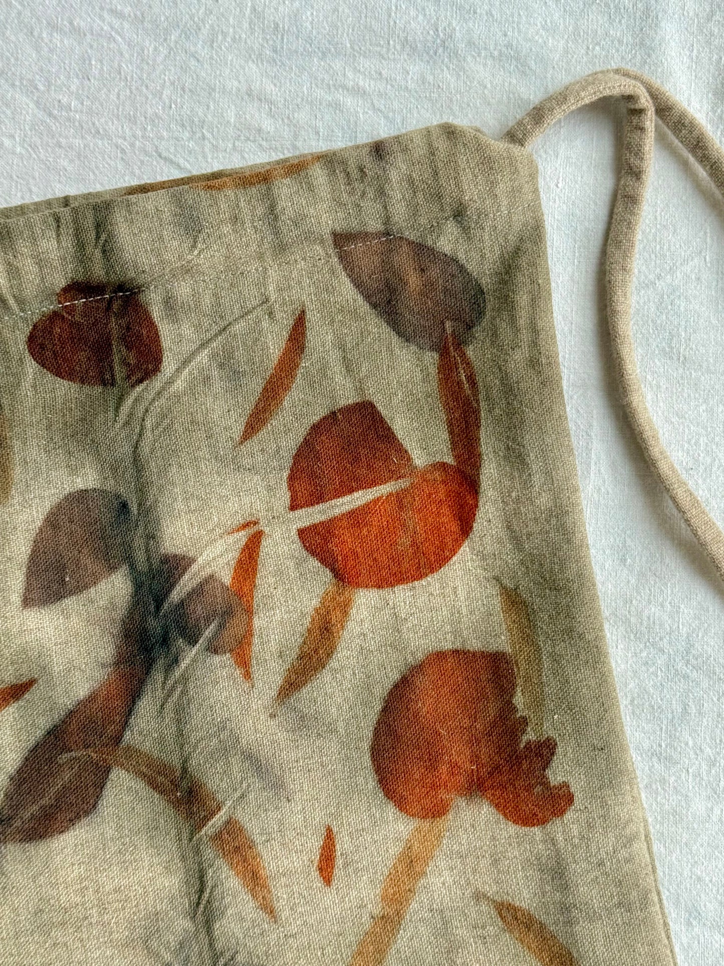 front of an eco-printed woolen bag - detail of an eucalyptus leaf print