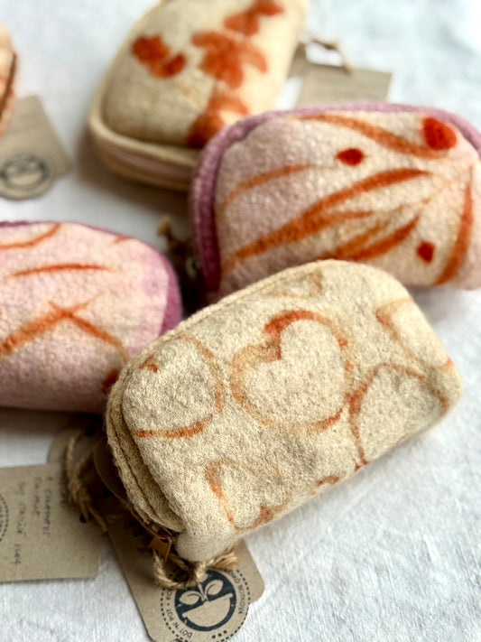 Heart-shaped patterns on eco-printed woolen purses by DOT 'N' POT