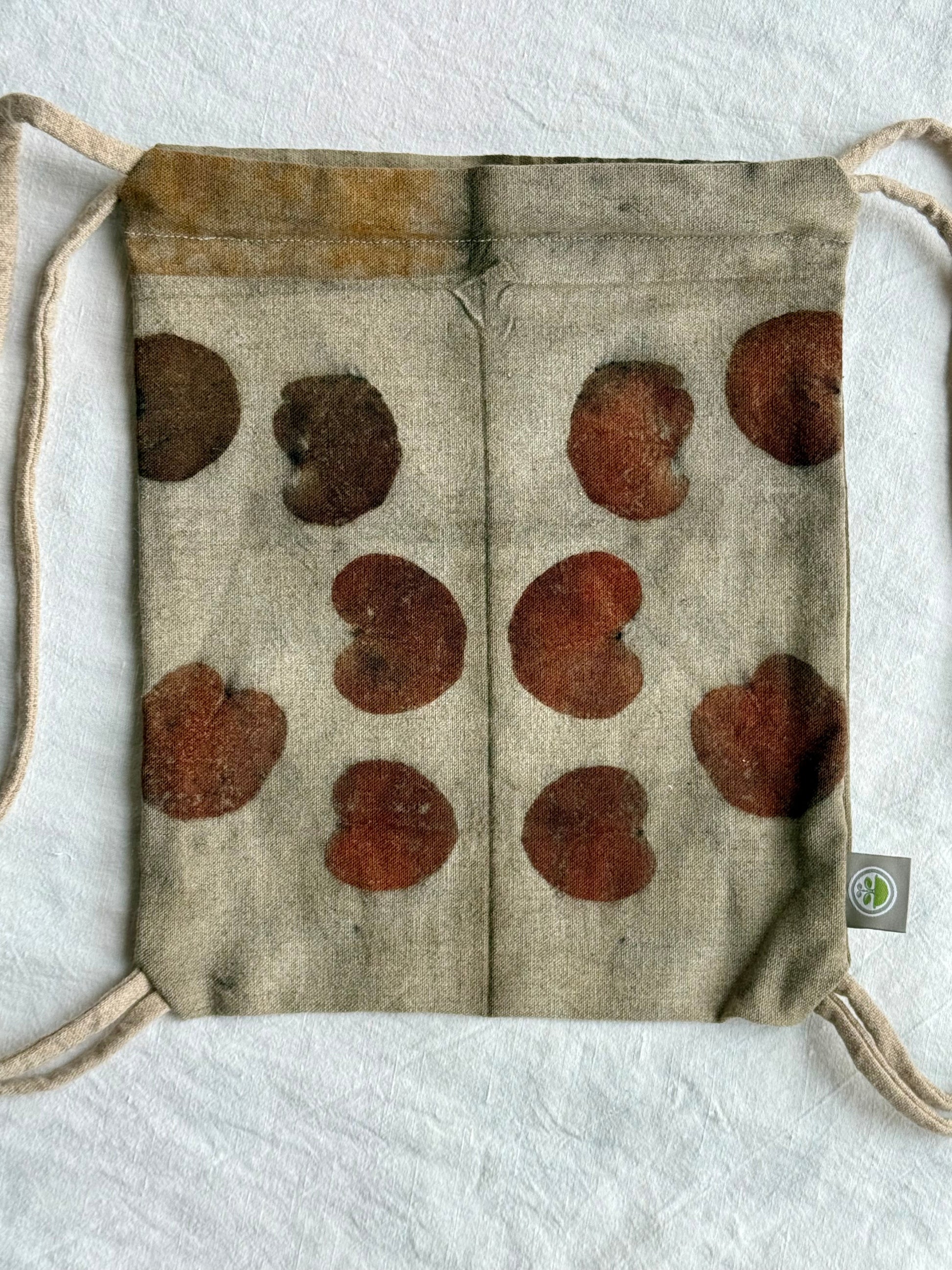 front part with eucalyptus leaves eco-printed on a woolen drawstring bag by DOT 'N' POT