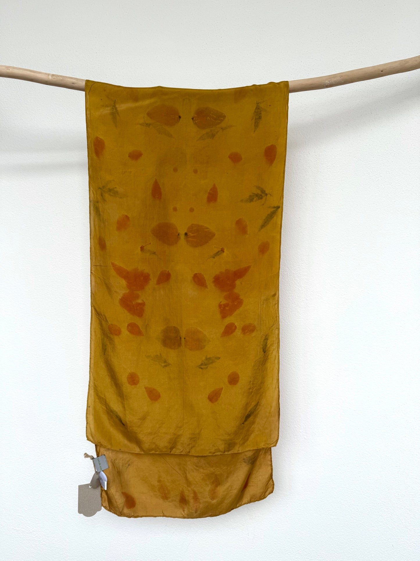 silk scarf naturally dyed with onion skins and eco-printed with eucalyptus leaves by DOT 'N' POT with a tag