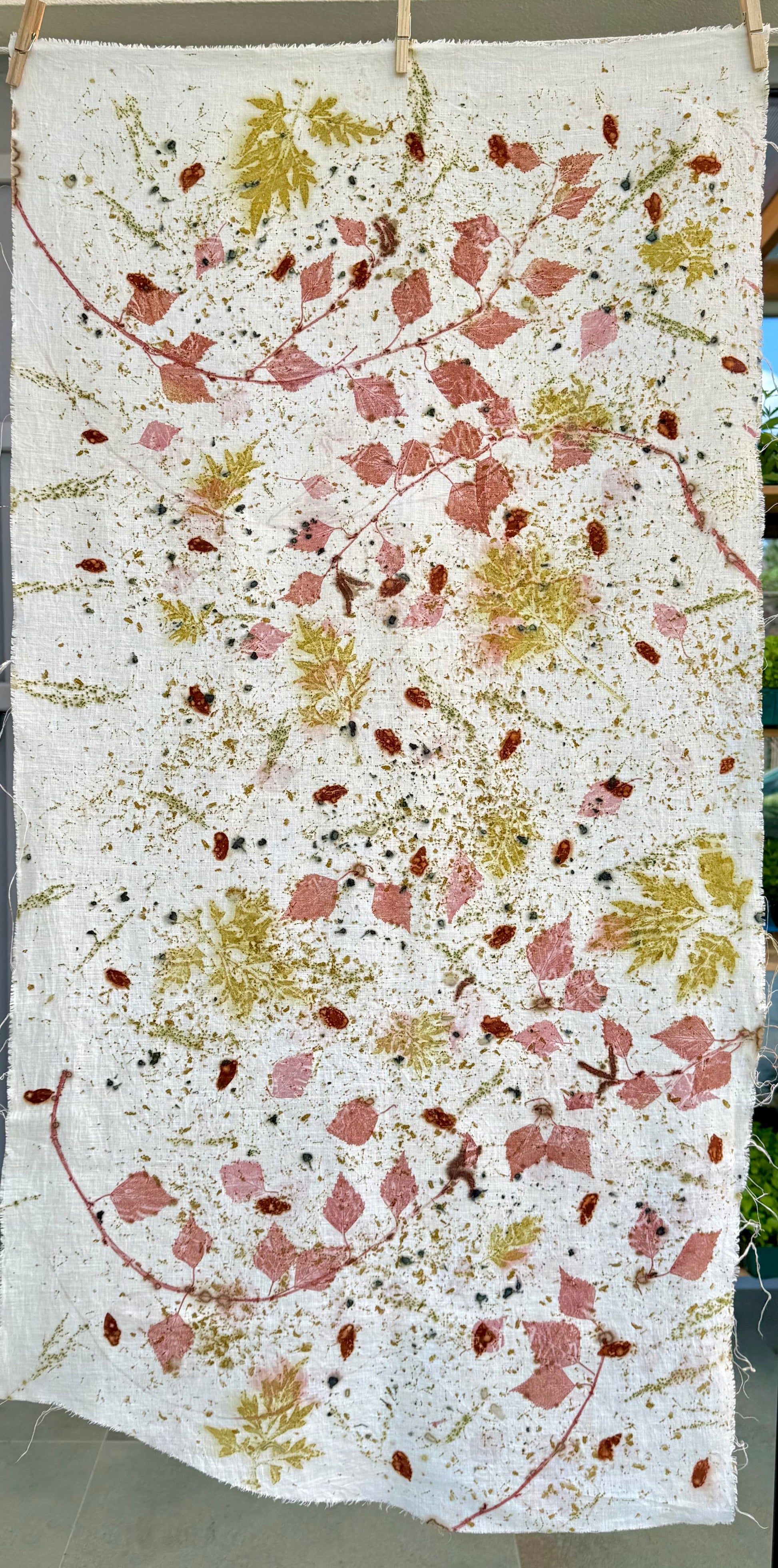 Textile with floral pattern on a white background, eco-printed with various leaves and flowers