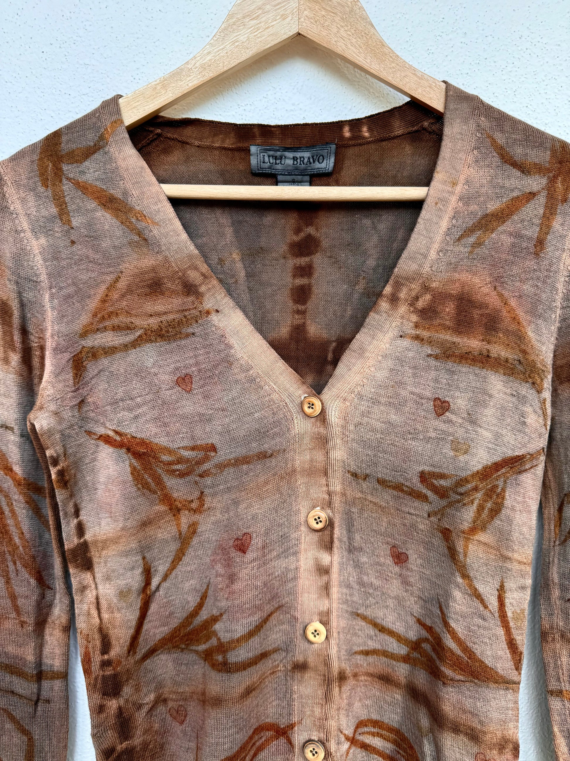Brown patterned cardigan on a hanger against a white background - with eucalyptus eco-print by DOT 'N' POT