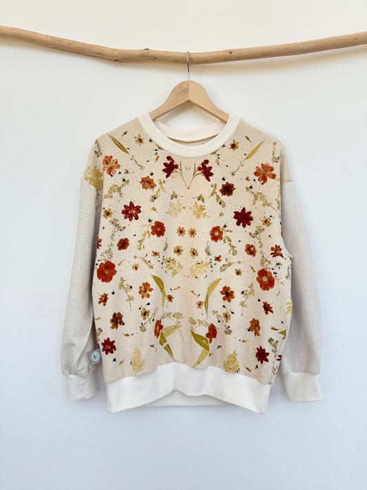 Boyfriend sweater eco-printed with flowers on a hanger against a white wall by DOT 'N' POT