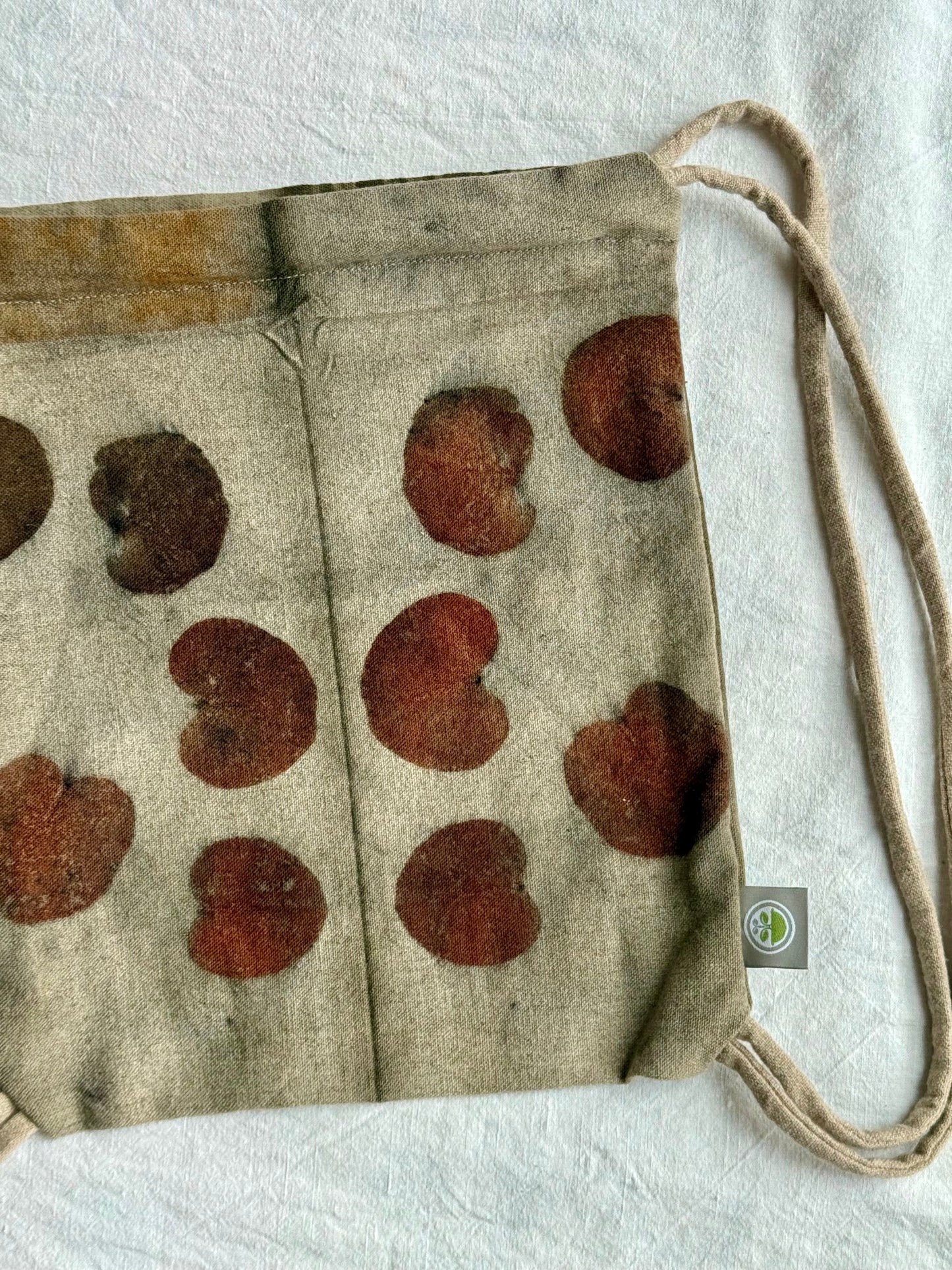 front part with eucalyptus leaves eco-printed on a woolen, naturally gray colored drawstring bag by DOT 'N' POT