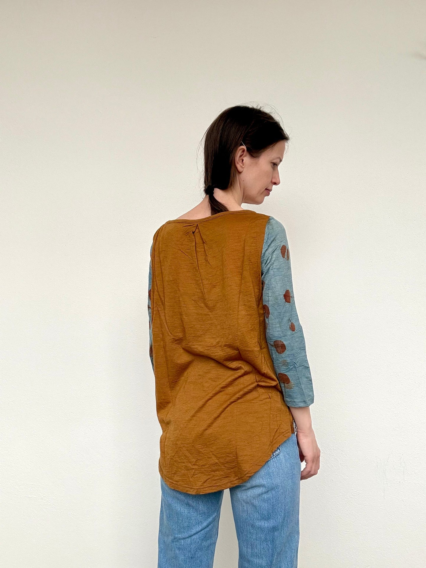 back part of a merino wool top dyed with onion skins, eucalyptus and indigo