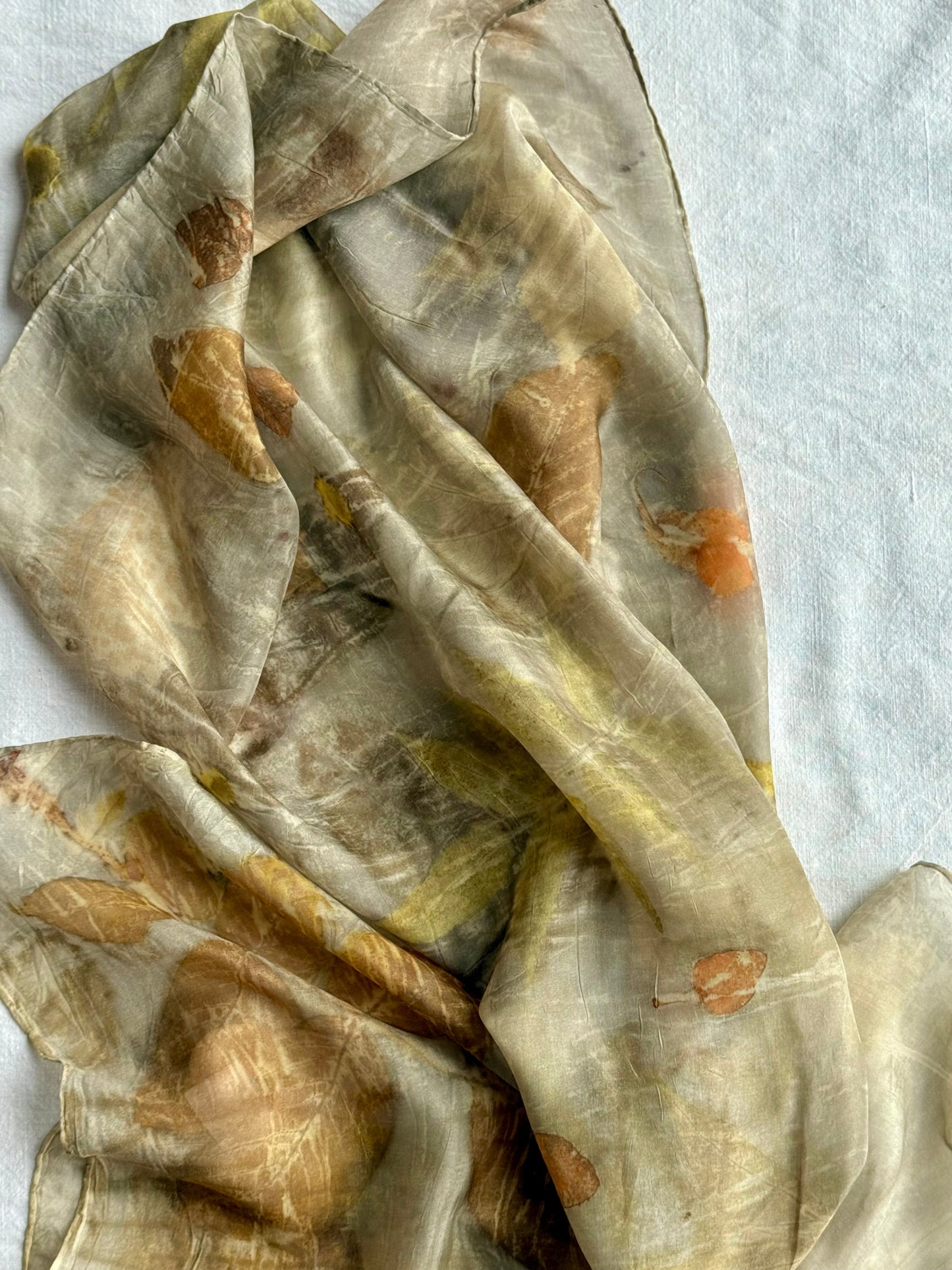 naturally dyed brown-gray silk scarf on white background