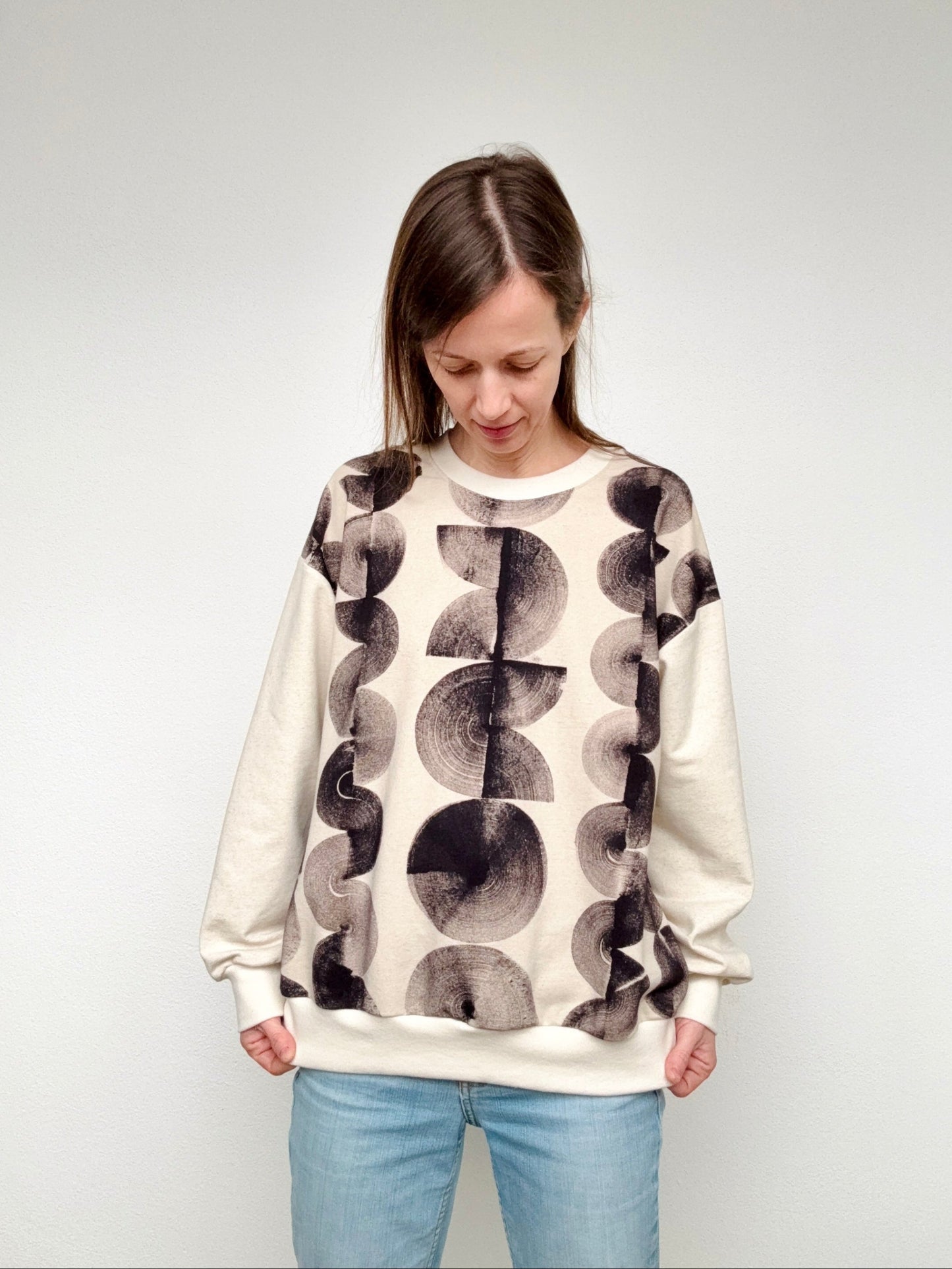 Woman wearing a boyfriend sweater naturally hand-painted with black marks by DOT 'N' POT