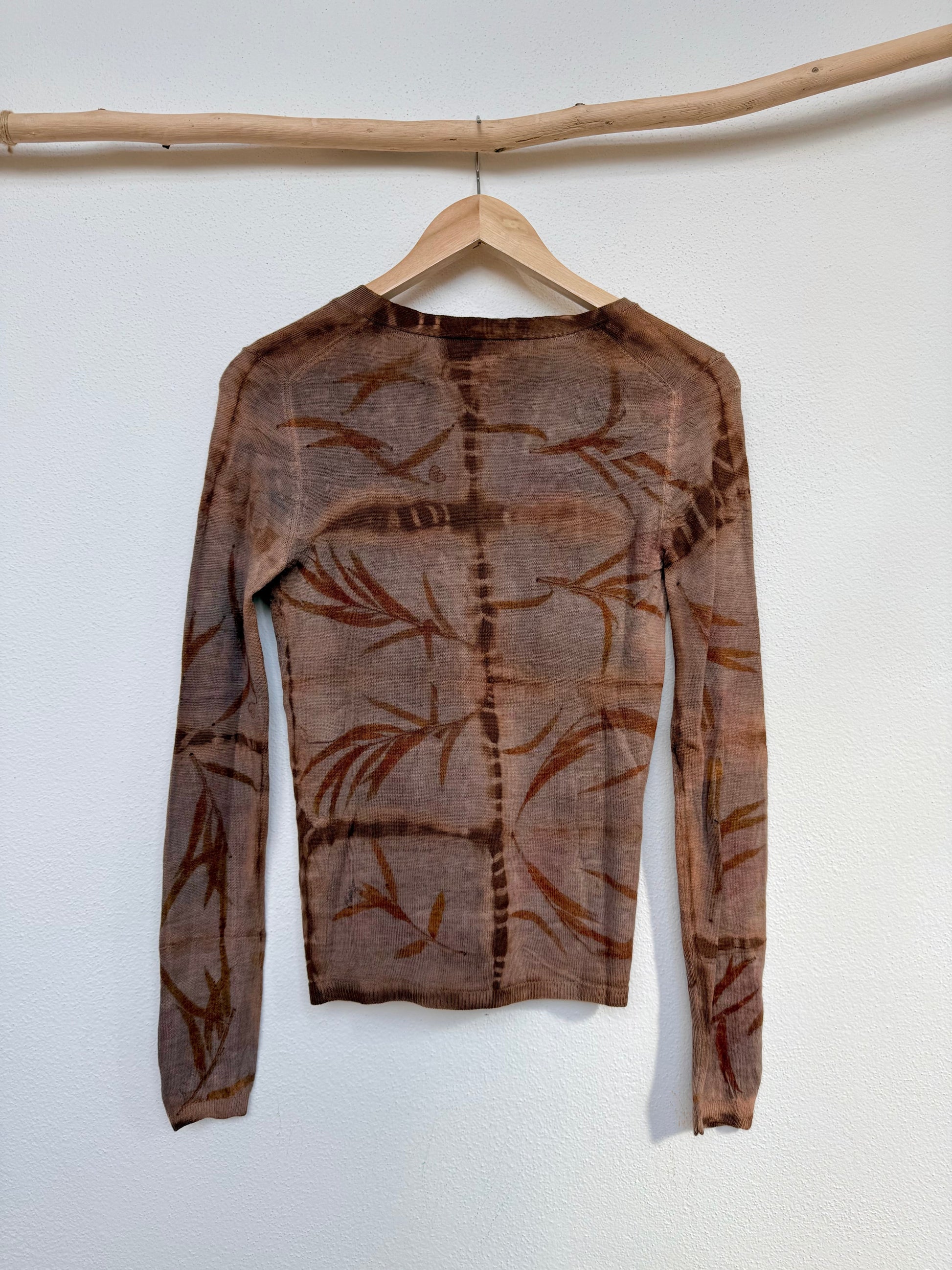 back of a nturally dyed woolen sweater with eucalyptus leaves pattern and cutch, walnut colour
