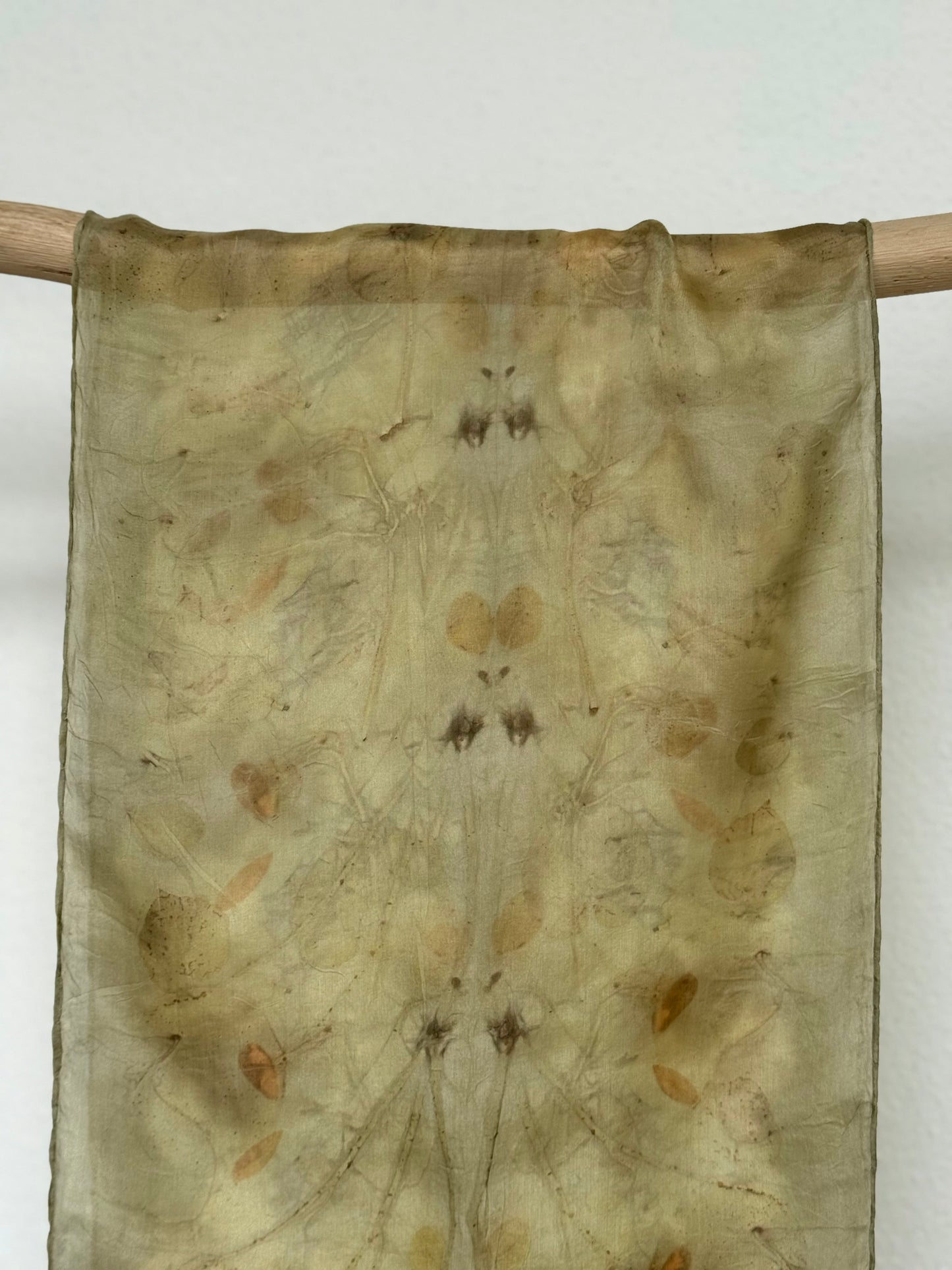green naturally dyed silk scarf hanging 