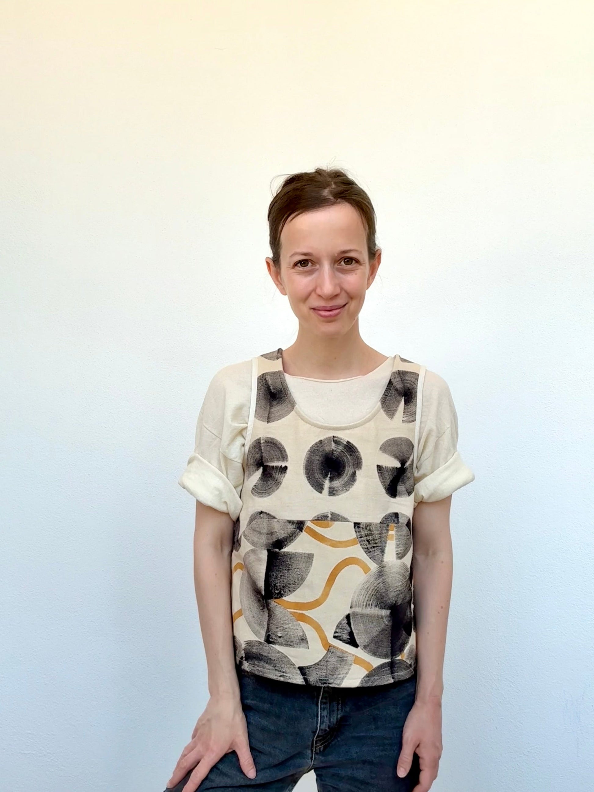 woman wearing a vest-top that was hand-painted with ferrous paste and cosmos sulphureus dye paste by DOT  'N' POT