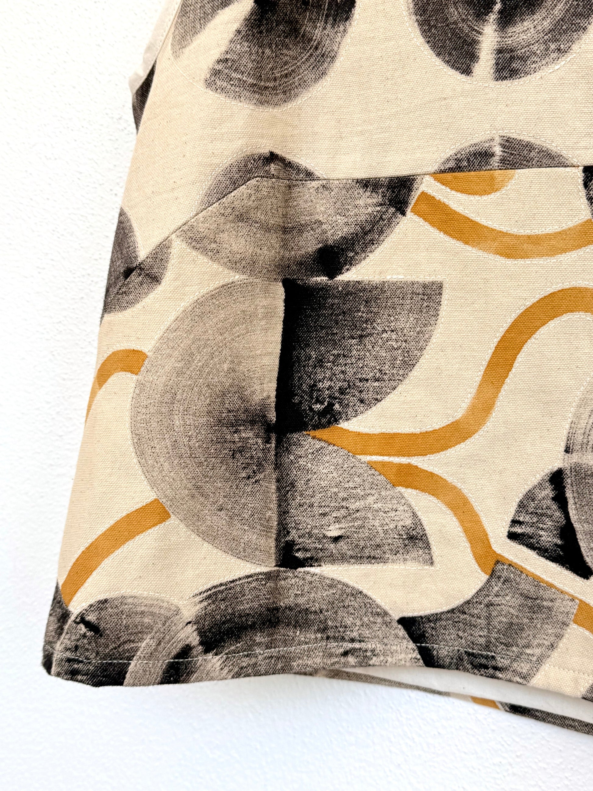 pattern hand-painted with ferrous paste on a beige canvas top
